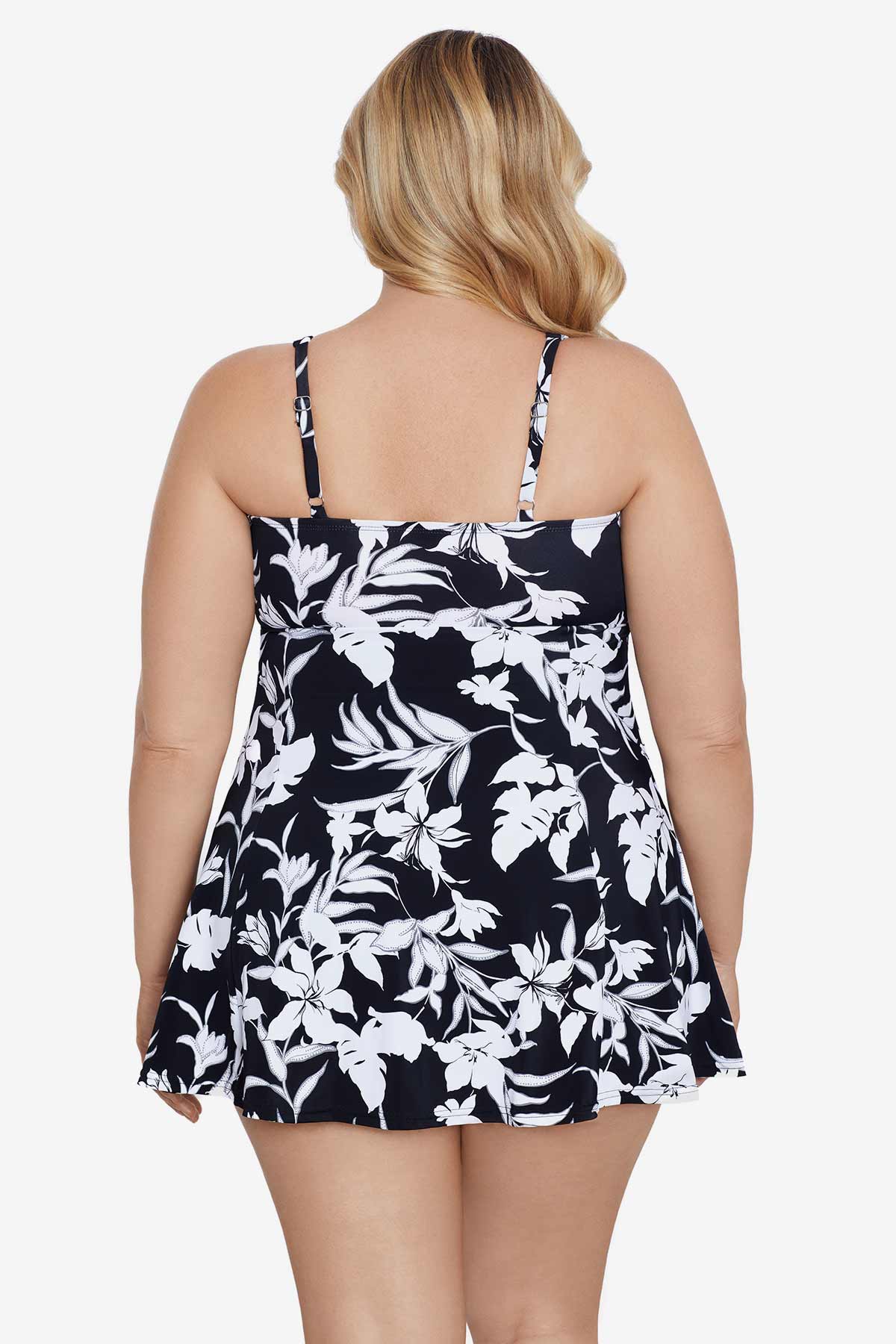 Woman turned away wearing a black and white floral printed bow front swim dress