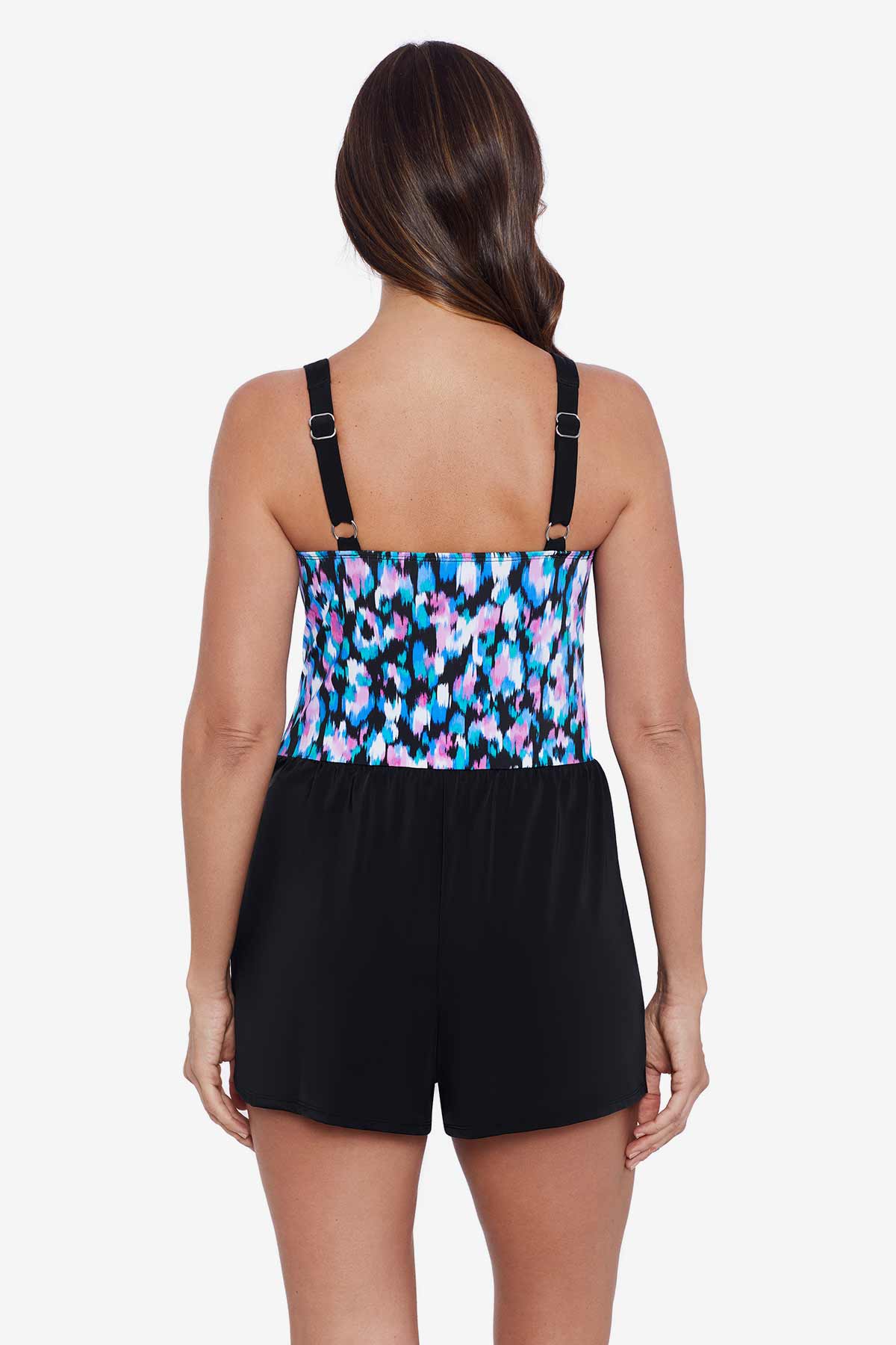 Woman faced away wearing a multicolored abstract printed skort romper