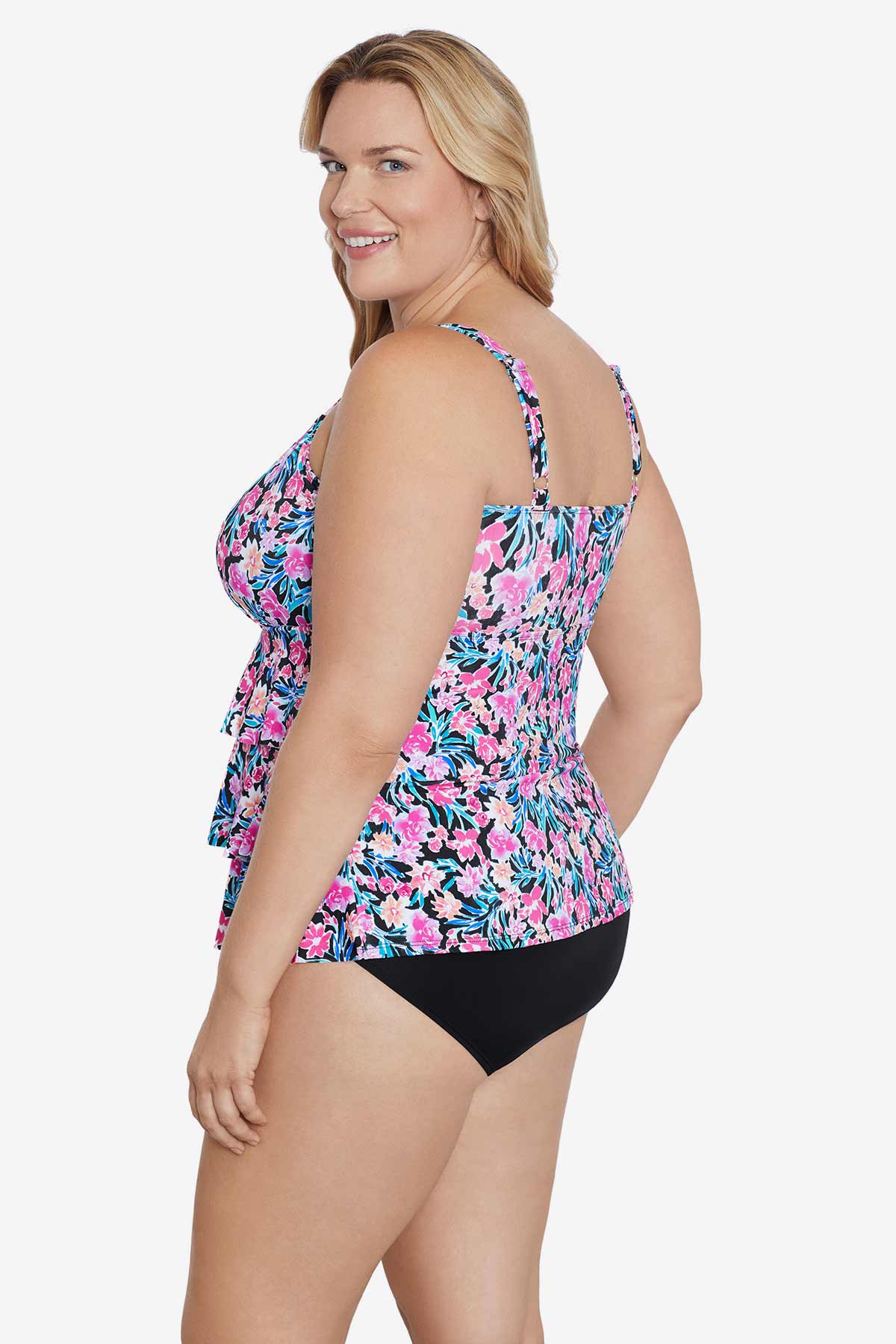 Woman turned left wearing a multicolored floral printed tiered ruffle tankini top