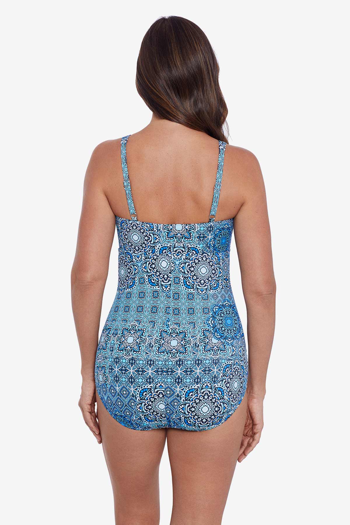 Woman faced away wearing a blue tile pattern one-piece swimsuit
