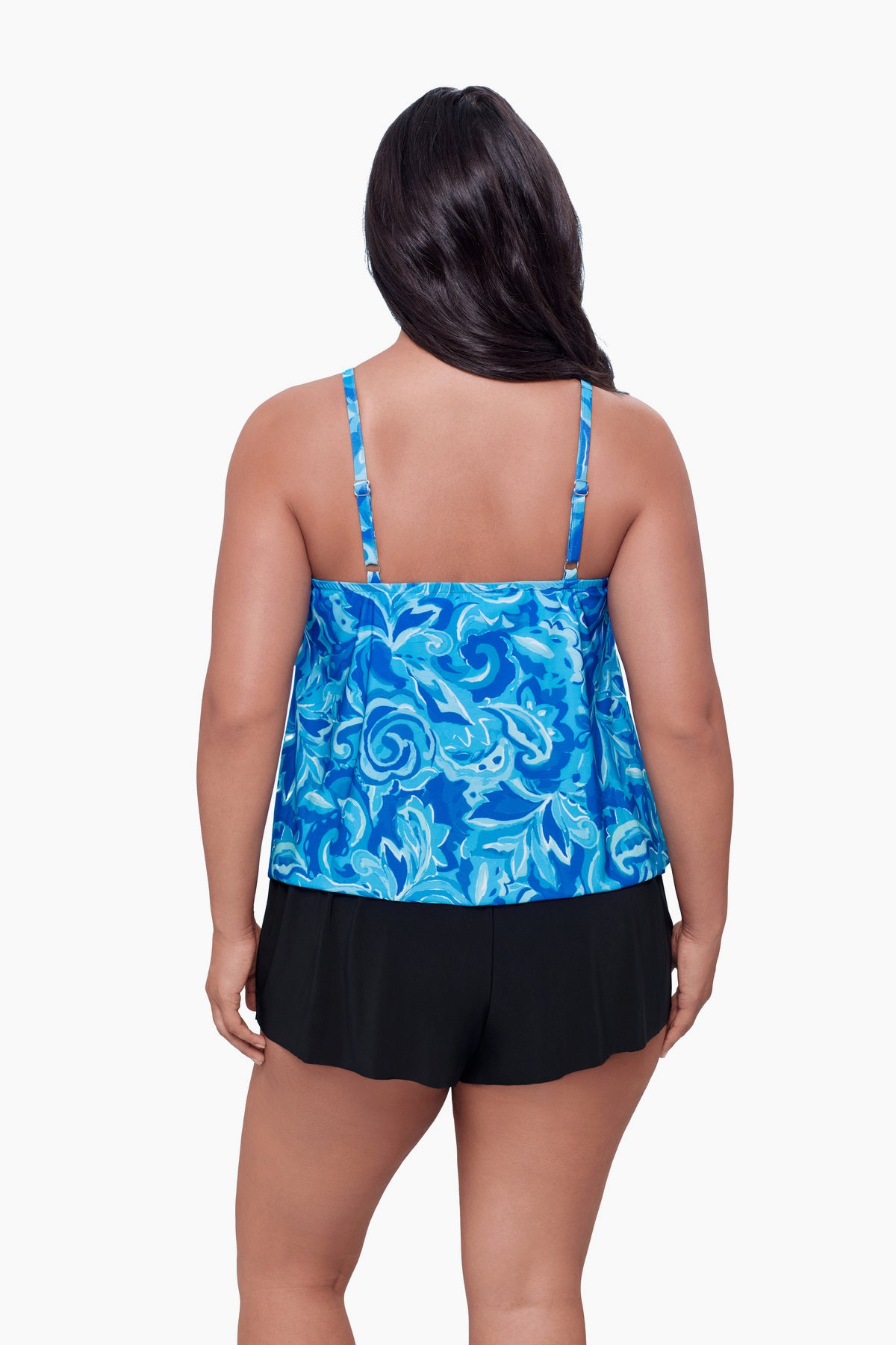 Woman turned away wearing a swim romper with a blue abstract print