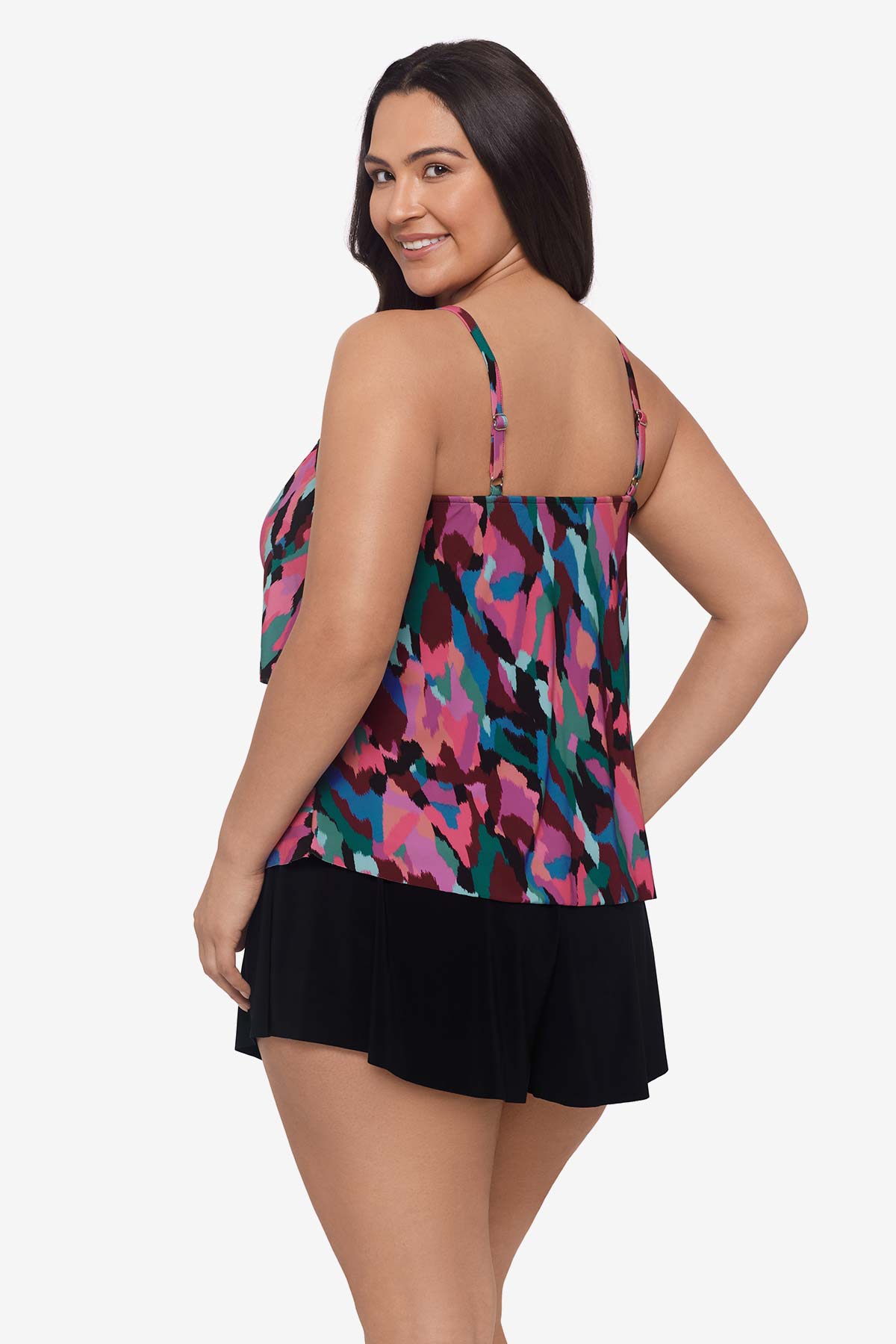 Woman faced left wearing a multicolored abstract collage printed tankini top with ruffles