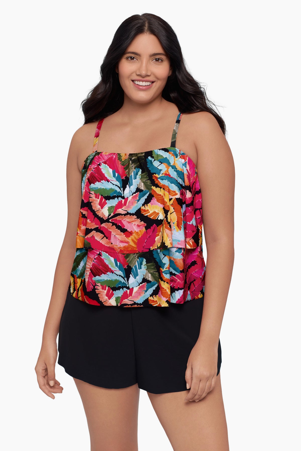 Woman wearing a swim romper with a bright multicolored floral pattern