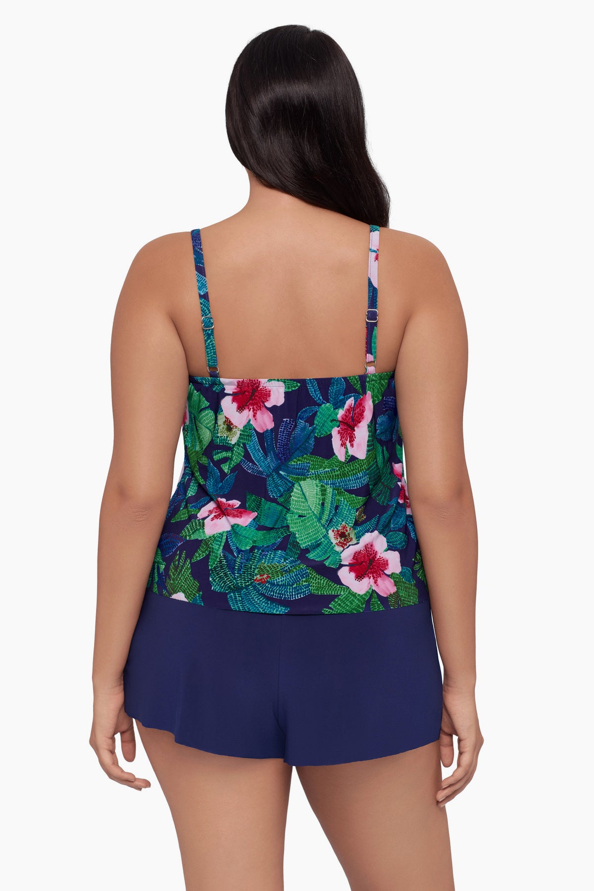 Woman turned away wearing a swim romper with a floral print