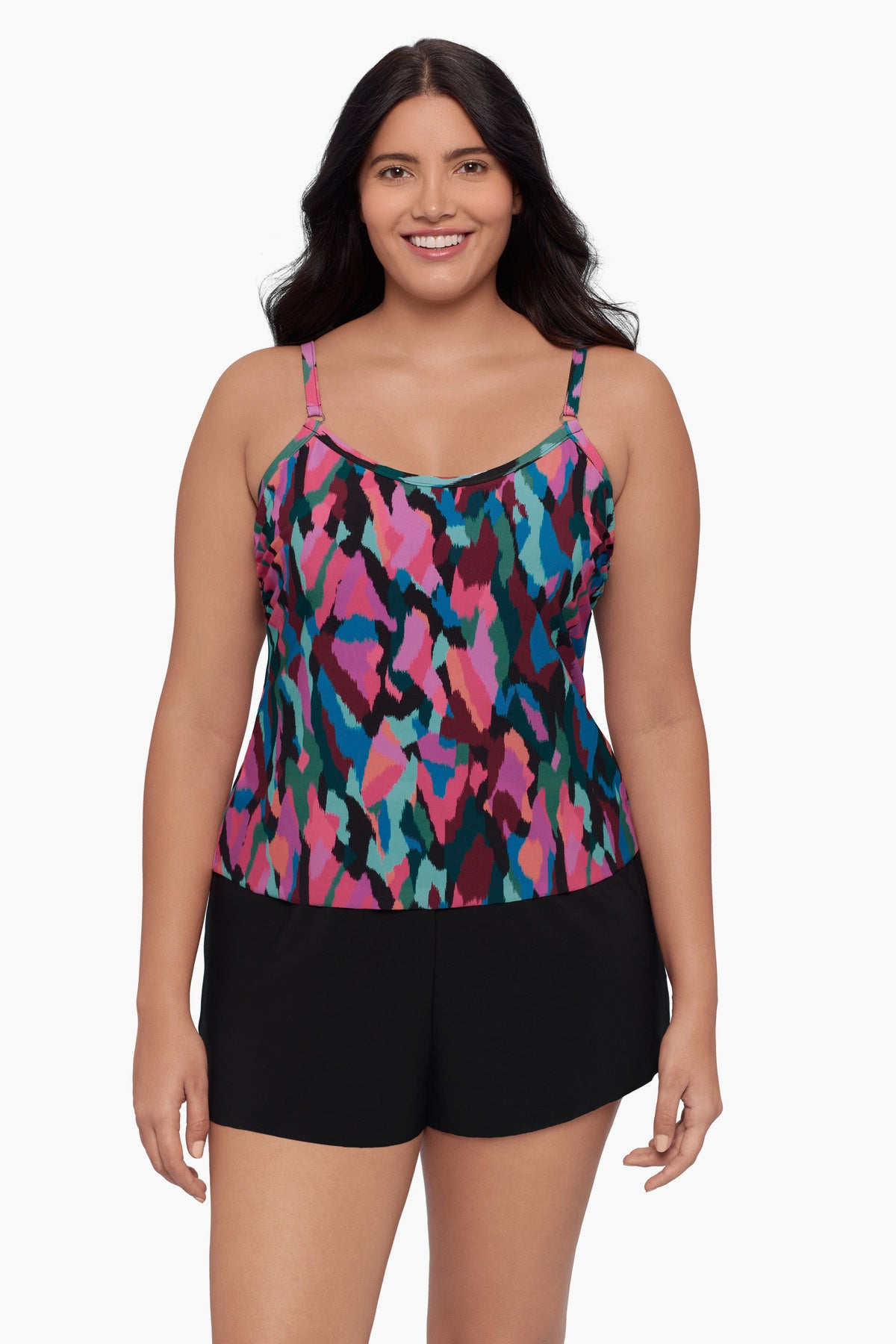 Woman wearing a swim romper with a collage patchwork pattern