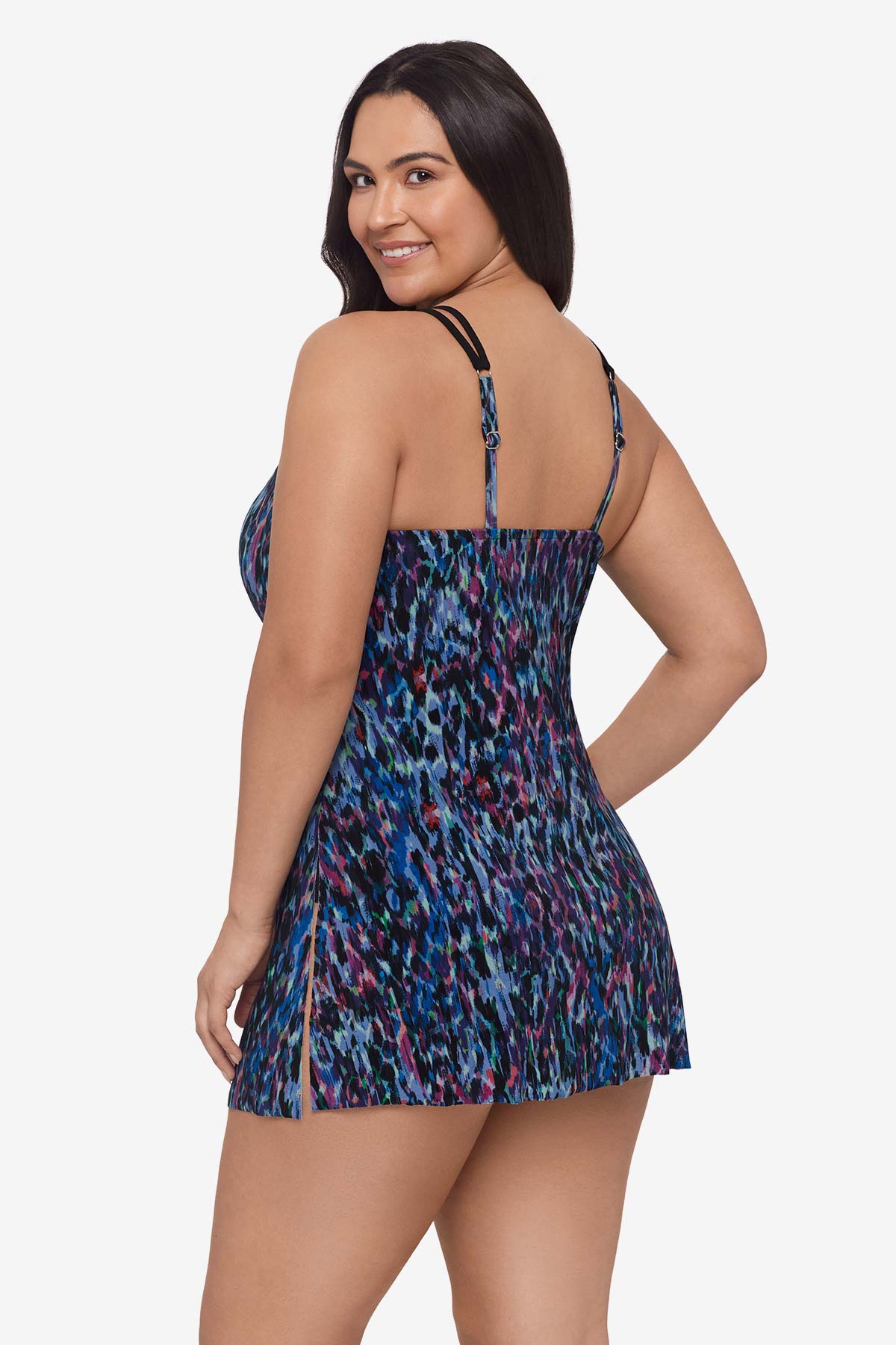 Woman faced left wearing a blue and purple abstract printed swim dress