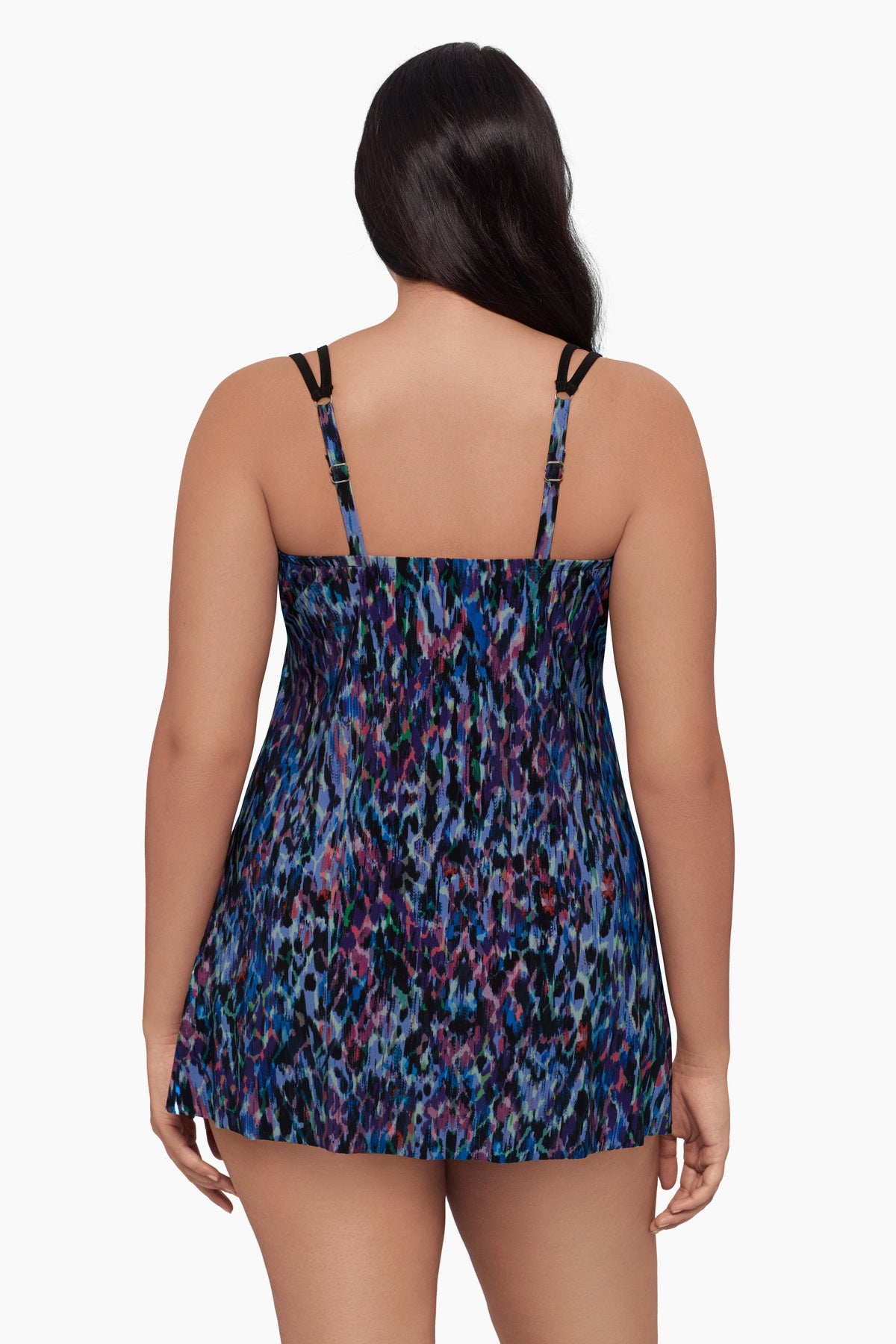 Woman turned away wearing a swim dress with a blue abstract pattern