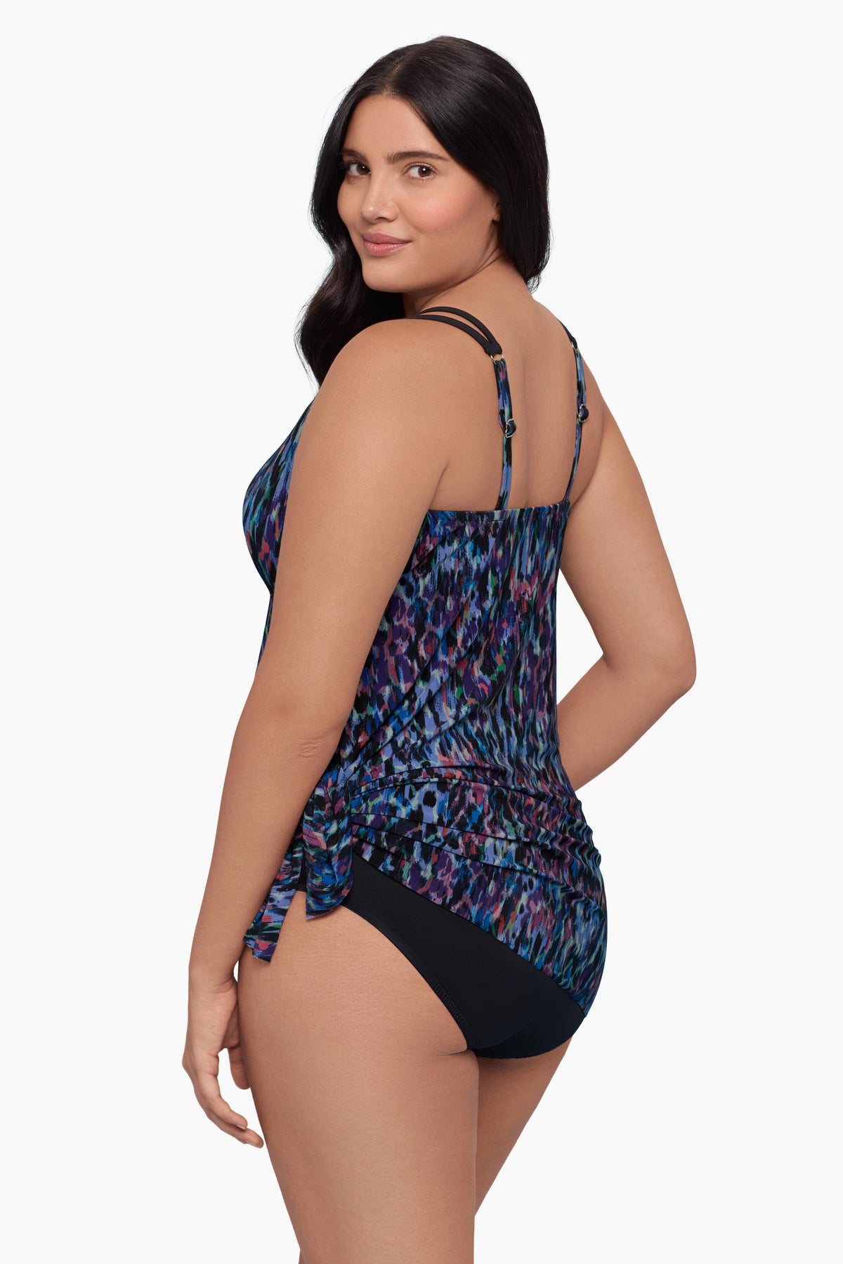 Woman turned left wearing a swim dress with a blue abstract pattern