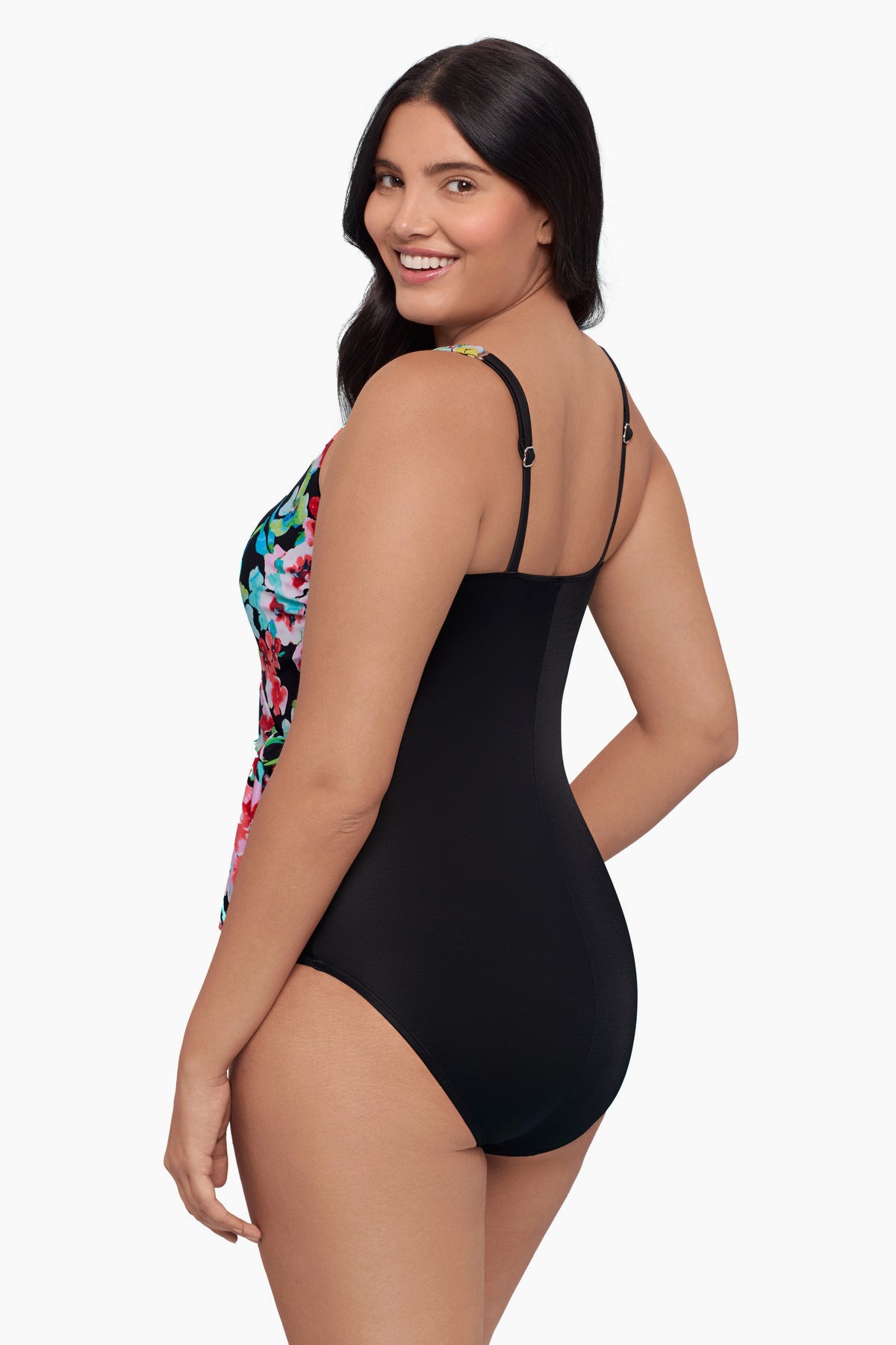 Woman faced left wearing a one-piece swimsuit with a floral print