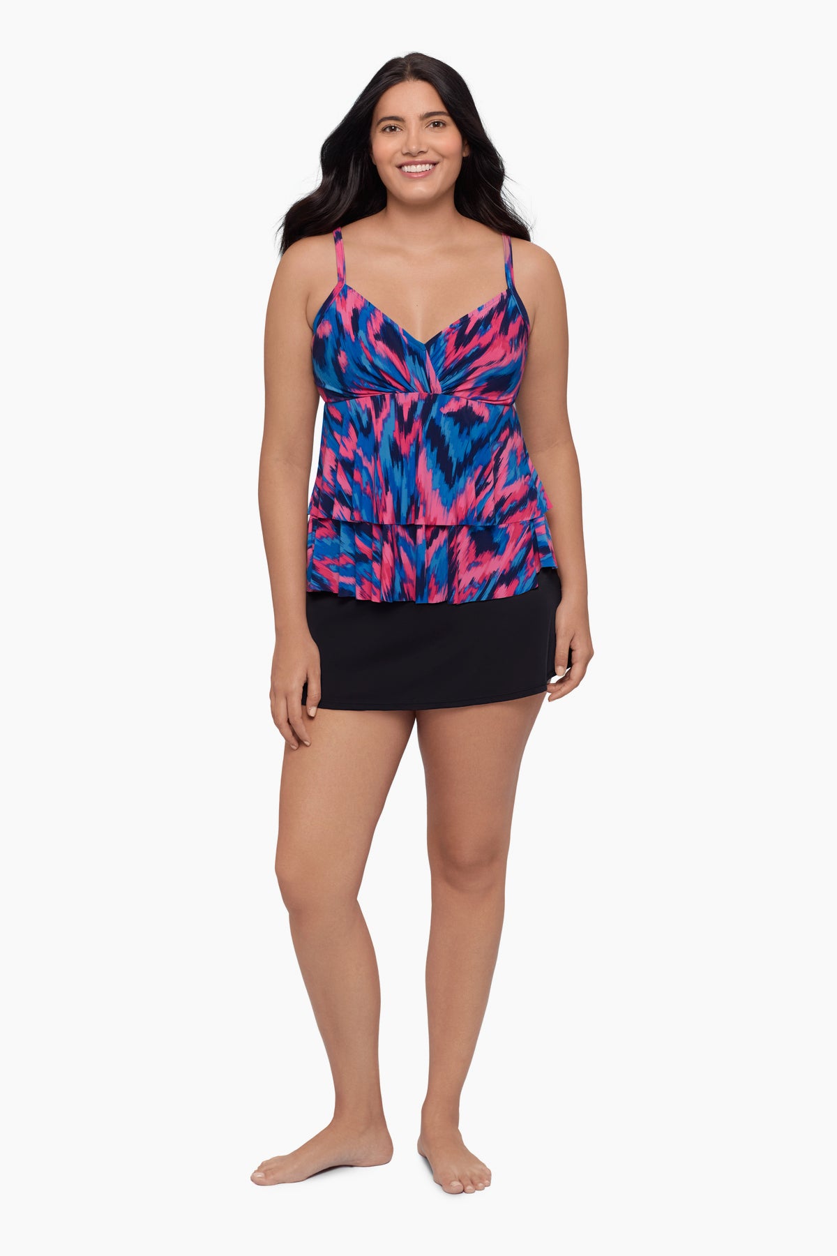 Woman wearing a tankini top with a pink and blue print
