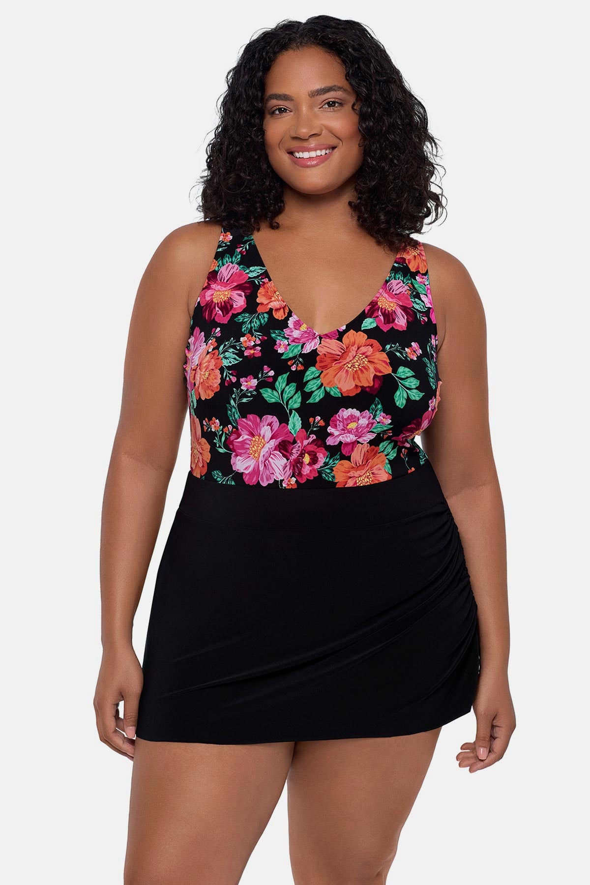 Woman wearing a pink and orange floral printed swim dress