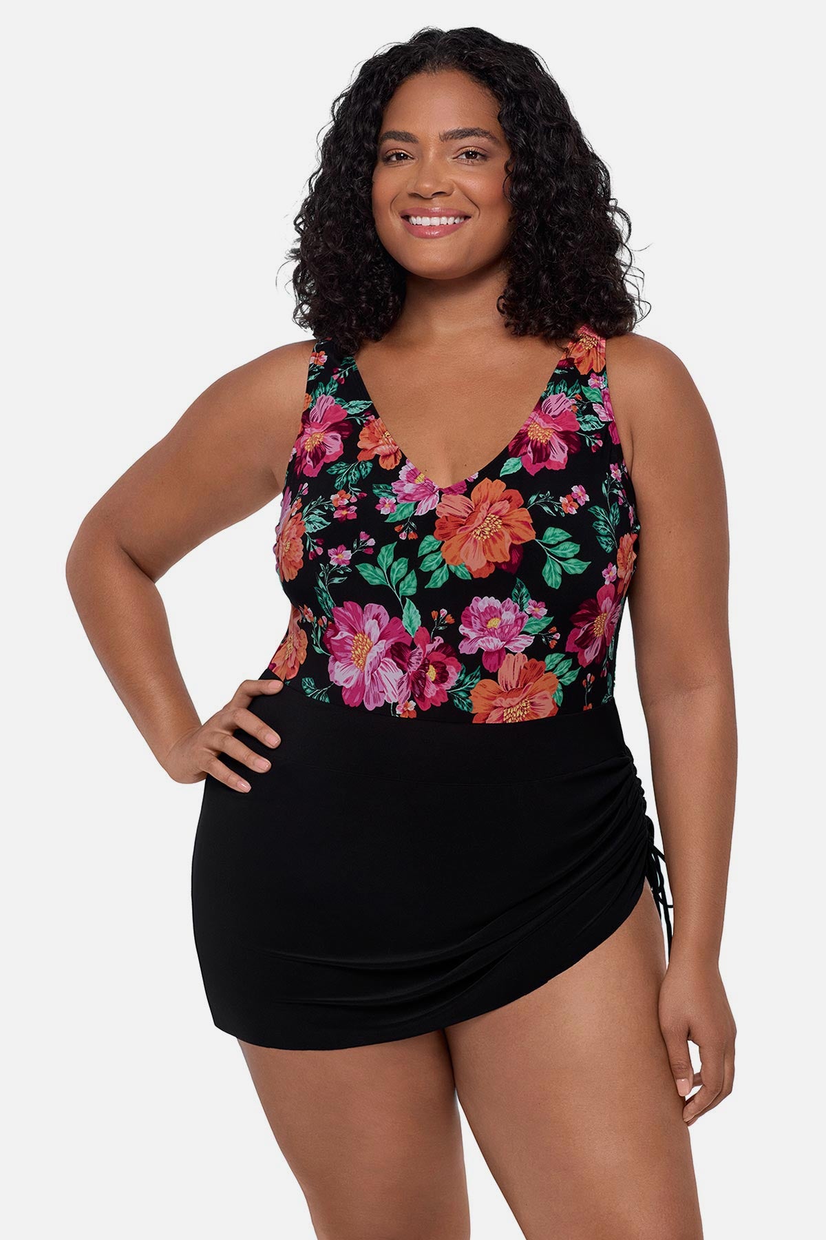 Woman wearing a pink and orange floral printed swim dress