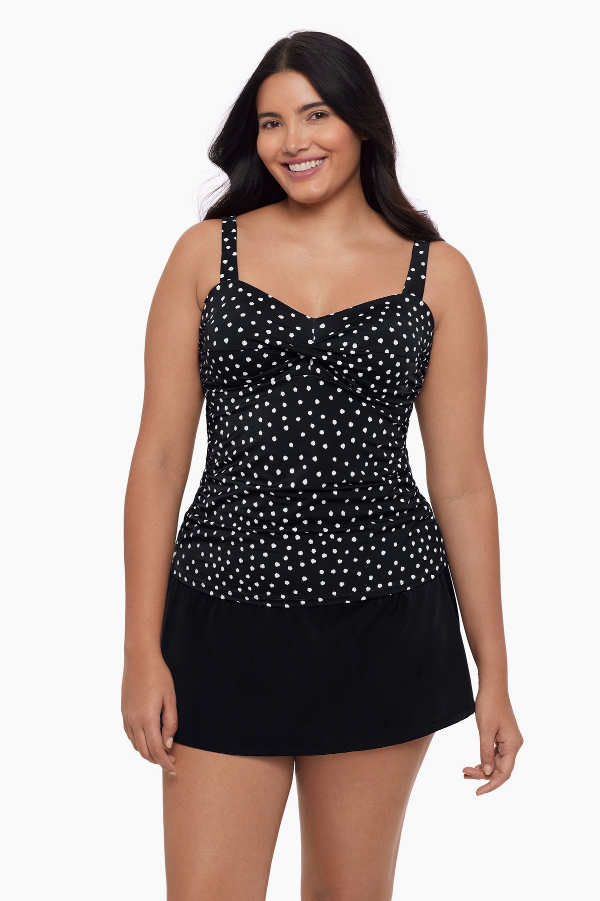 Woman wearing a tankini top with black and white polka dots