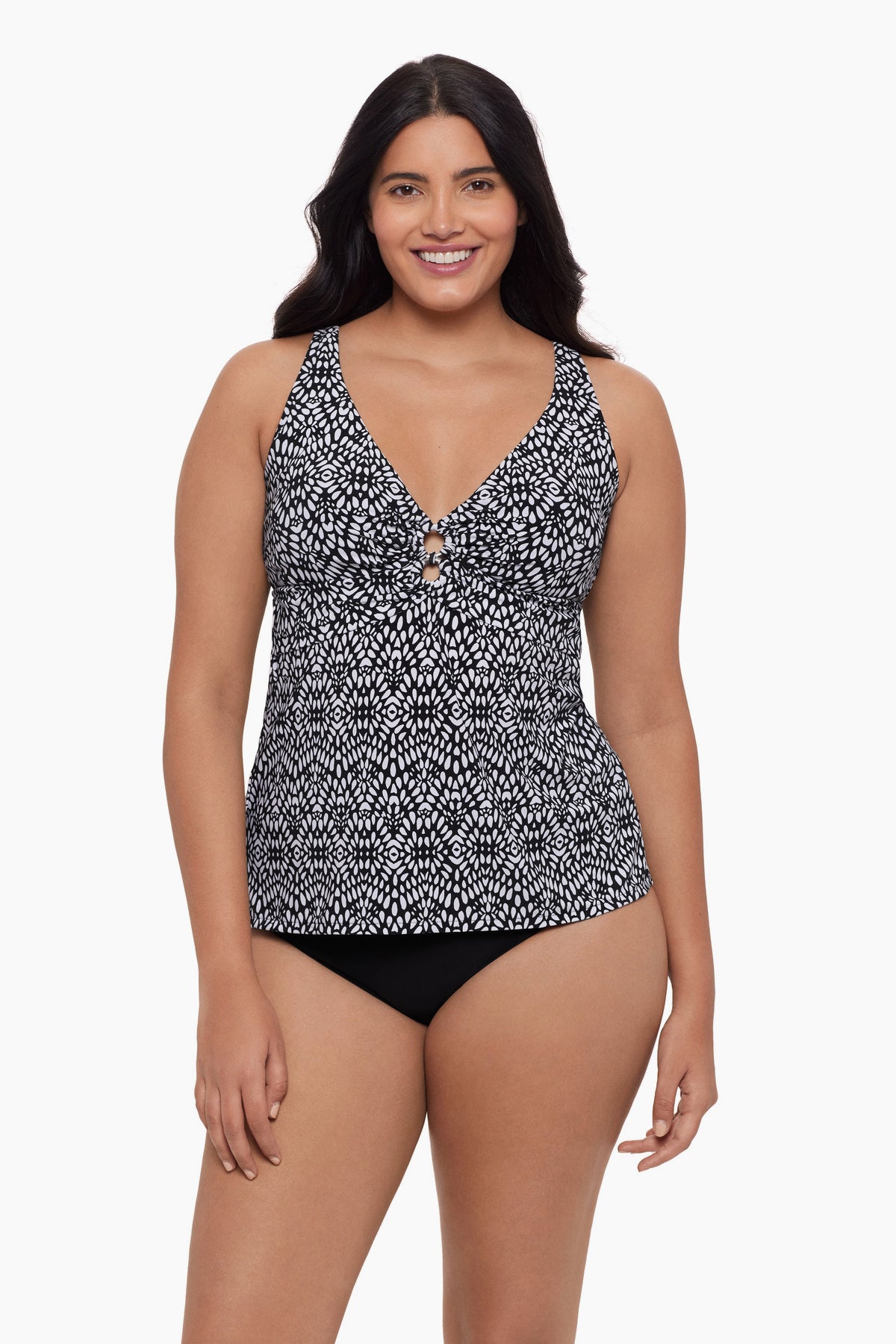 Woman wearing a tankini top with a black and white pattern