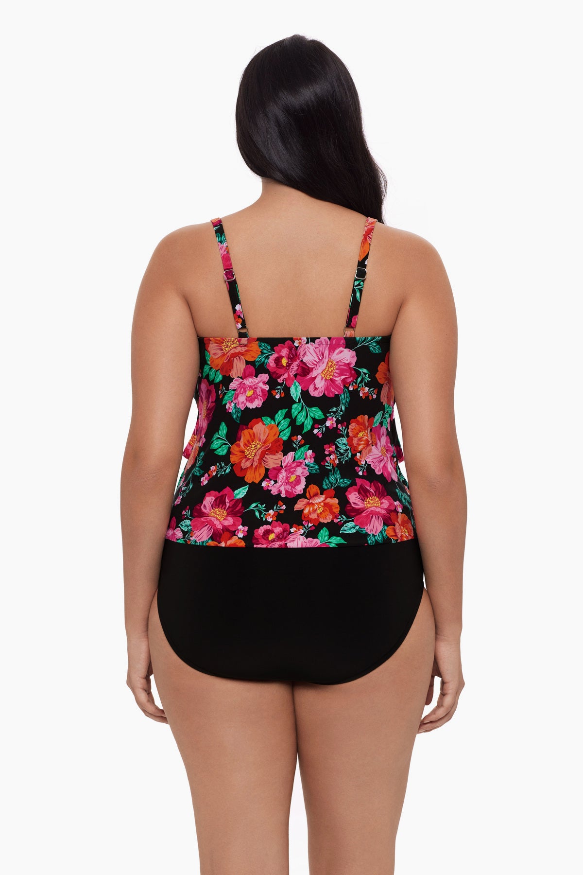 Woman turned away wearing a tankini top with a red and pink floral pattern