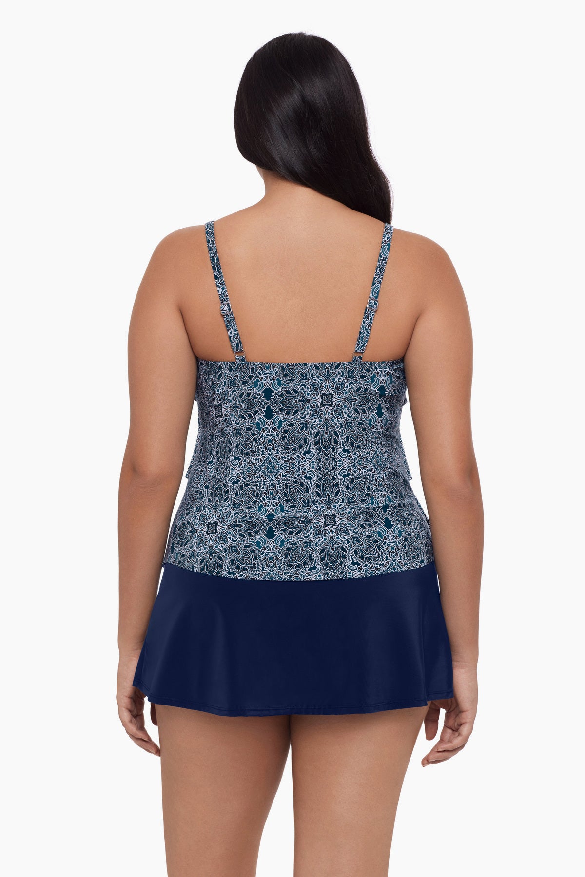 Woman turned away wearing a tankini top with a blue tile print