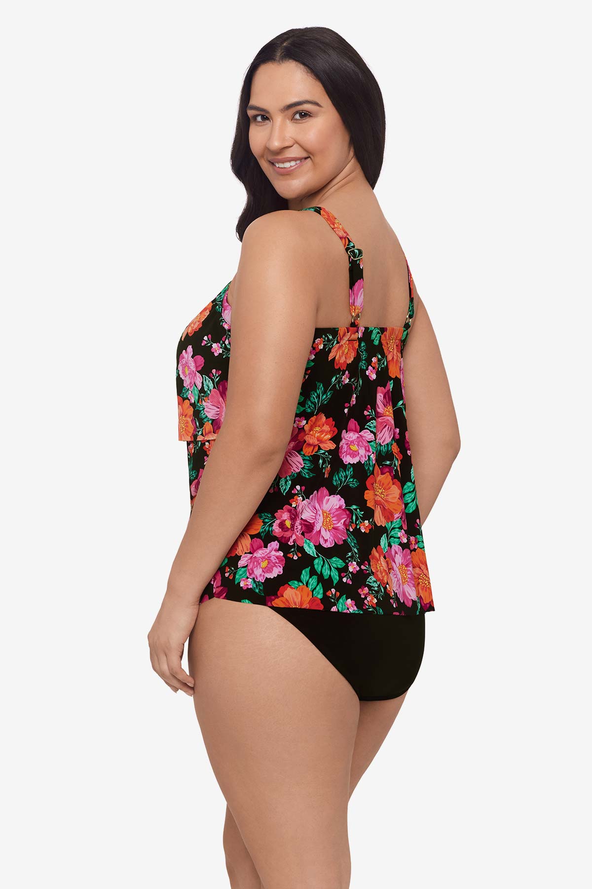Woman turned left wearing a pink and orange floral printed tankini top with ruffles