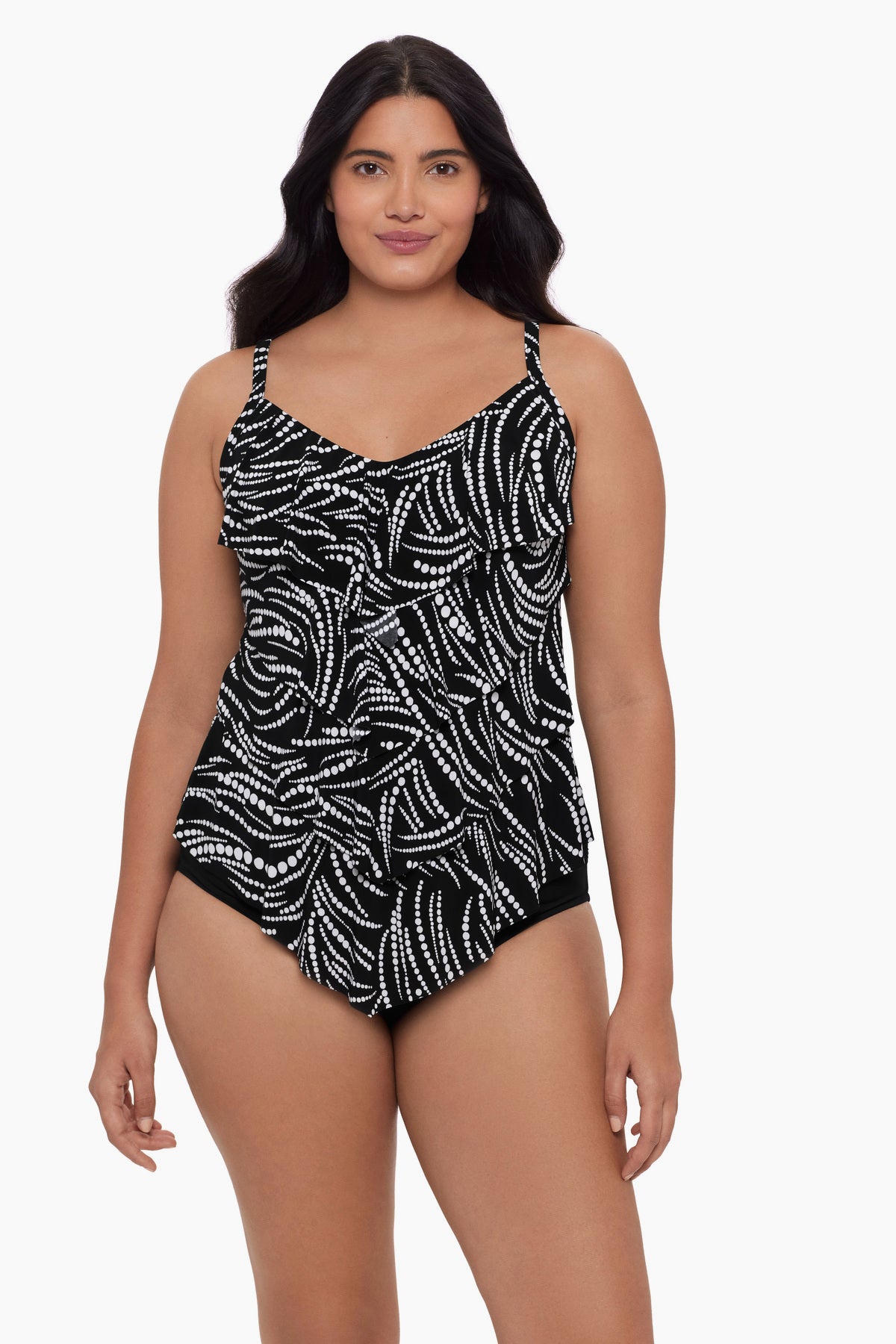 Woman wearing a tankini top with a black and white dot pattern