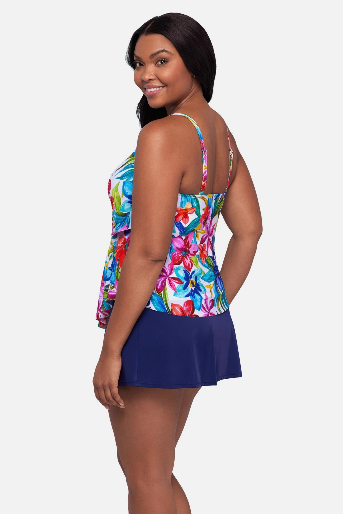 Woman turned left wearing a multicolored floral printed tankini top with ruffles