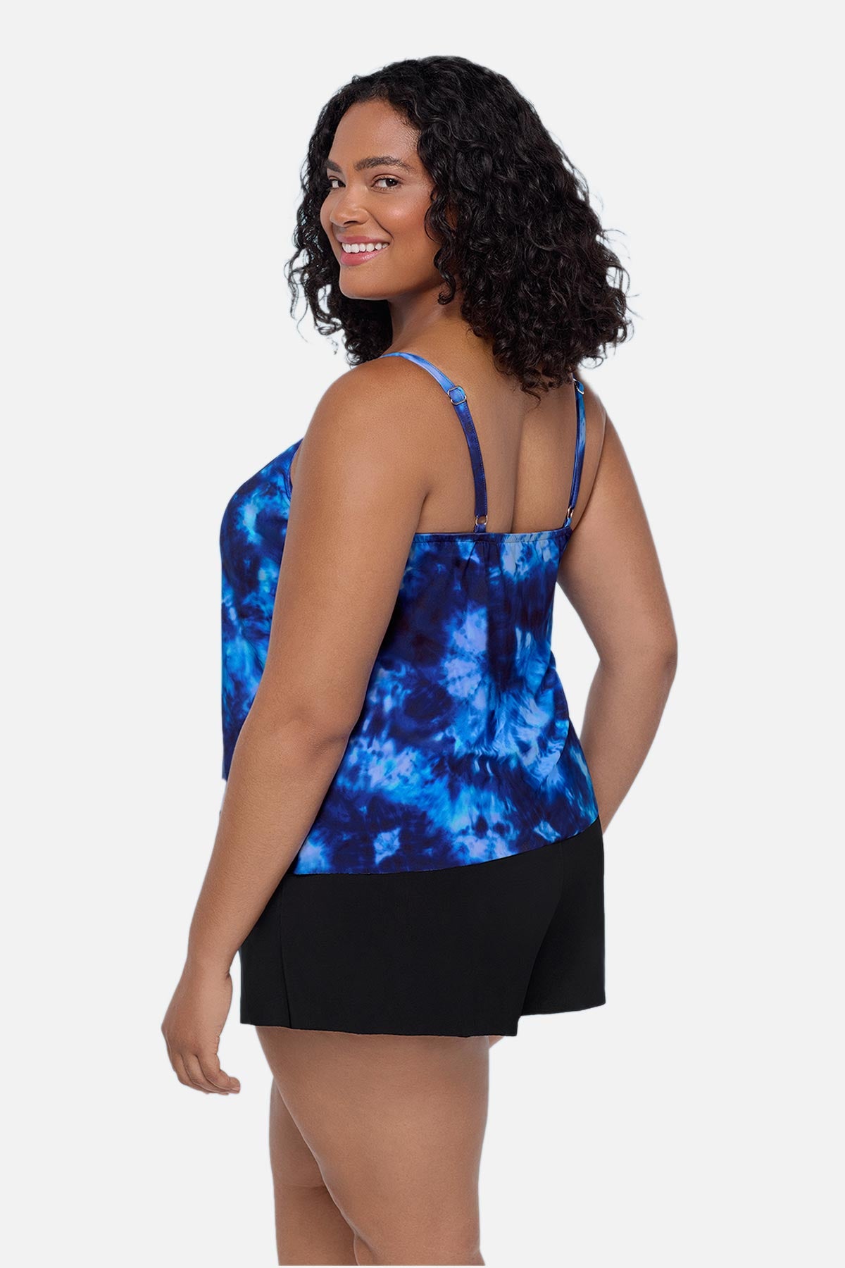 Woman turned left wearing a blue tie dye swim romper