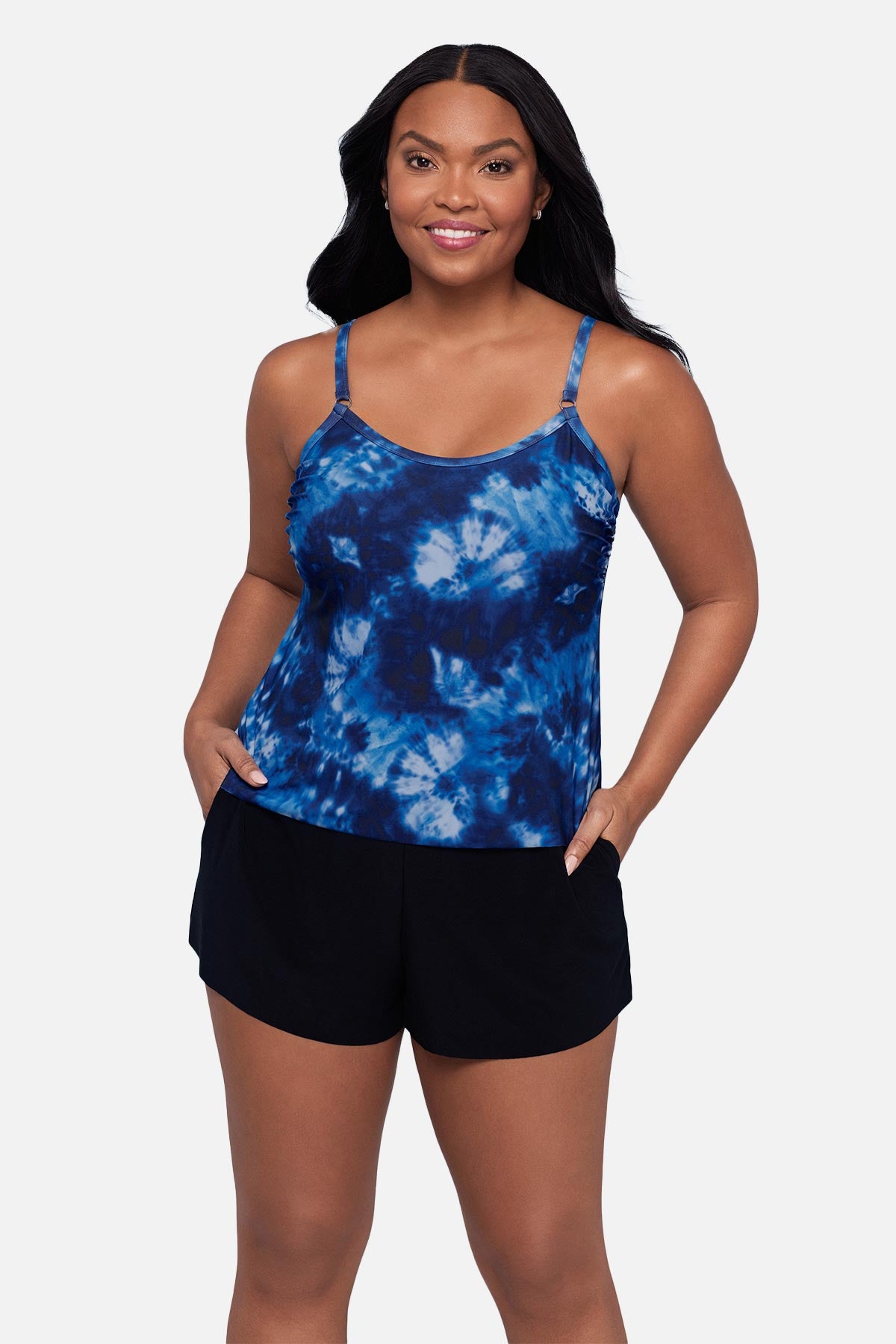 Woman wearing a blue tie dye swim romper with her hands in pocket