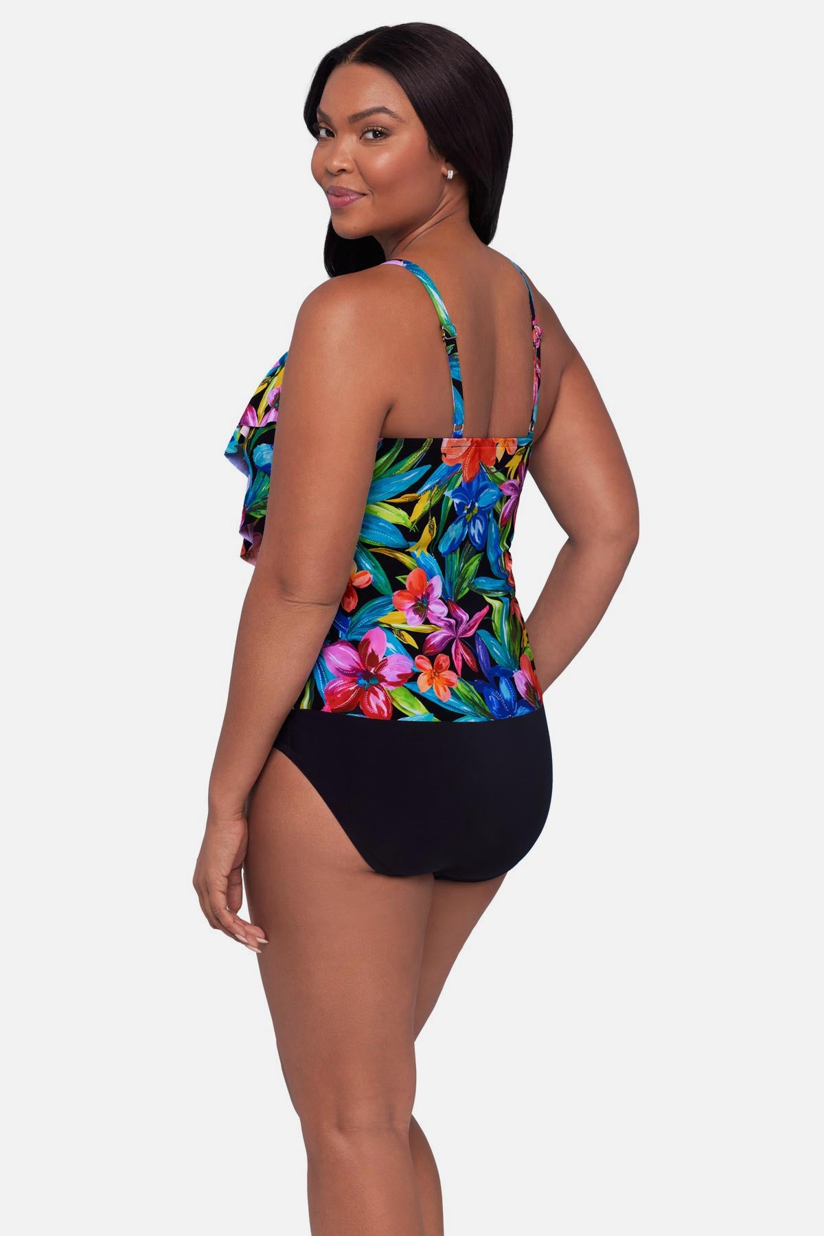 Woman turned left wearing a multicolored floral printed tankini top with ruffles