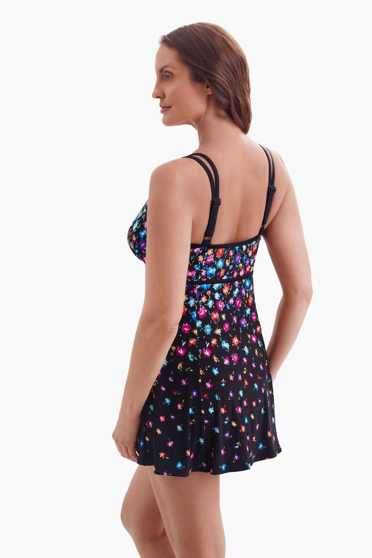 Woman faced left wearing a multicolored floral printed swim dress