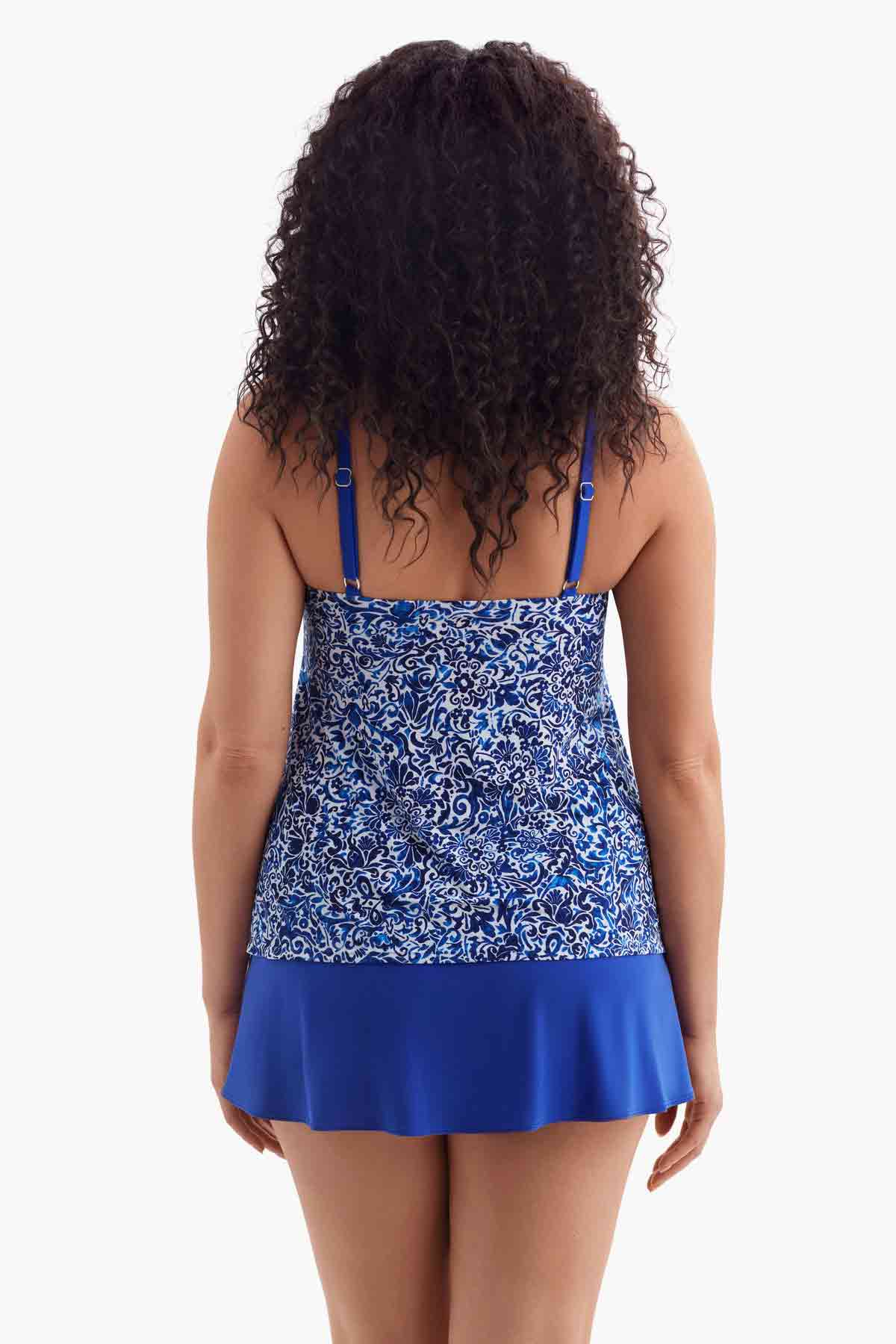 Woman turned away wearing a one-piece swimsuit with a blue and white pattern