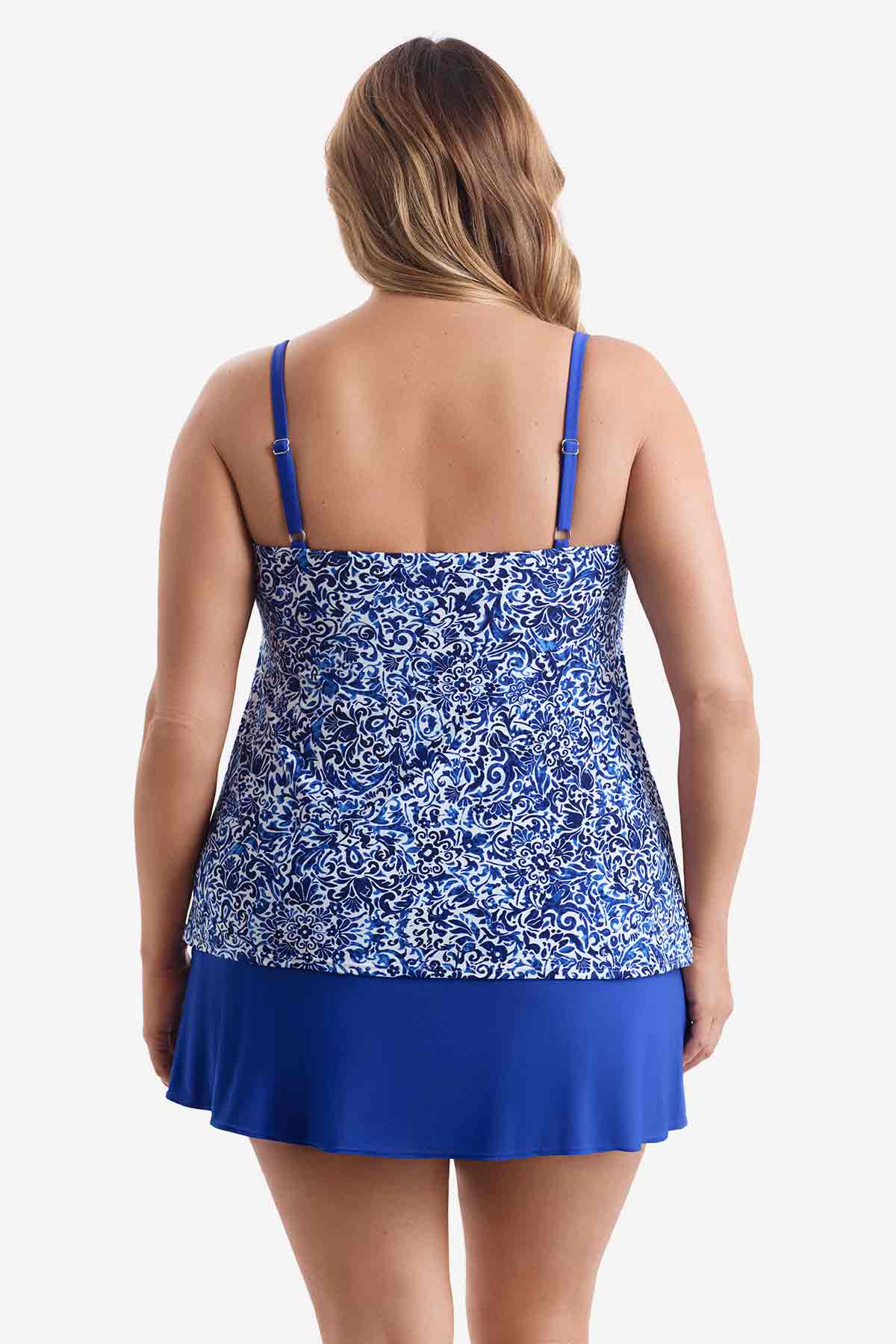 Woman faced away wearing a blue and white patterned tiered one-piece swimsuit