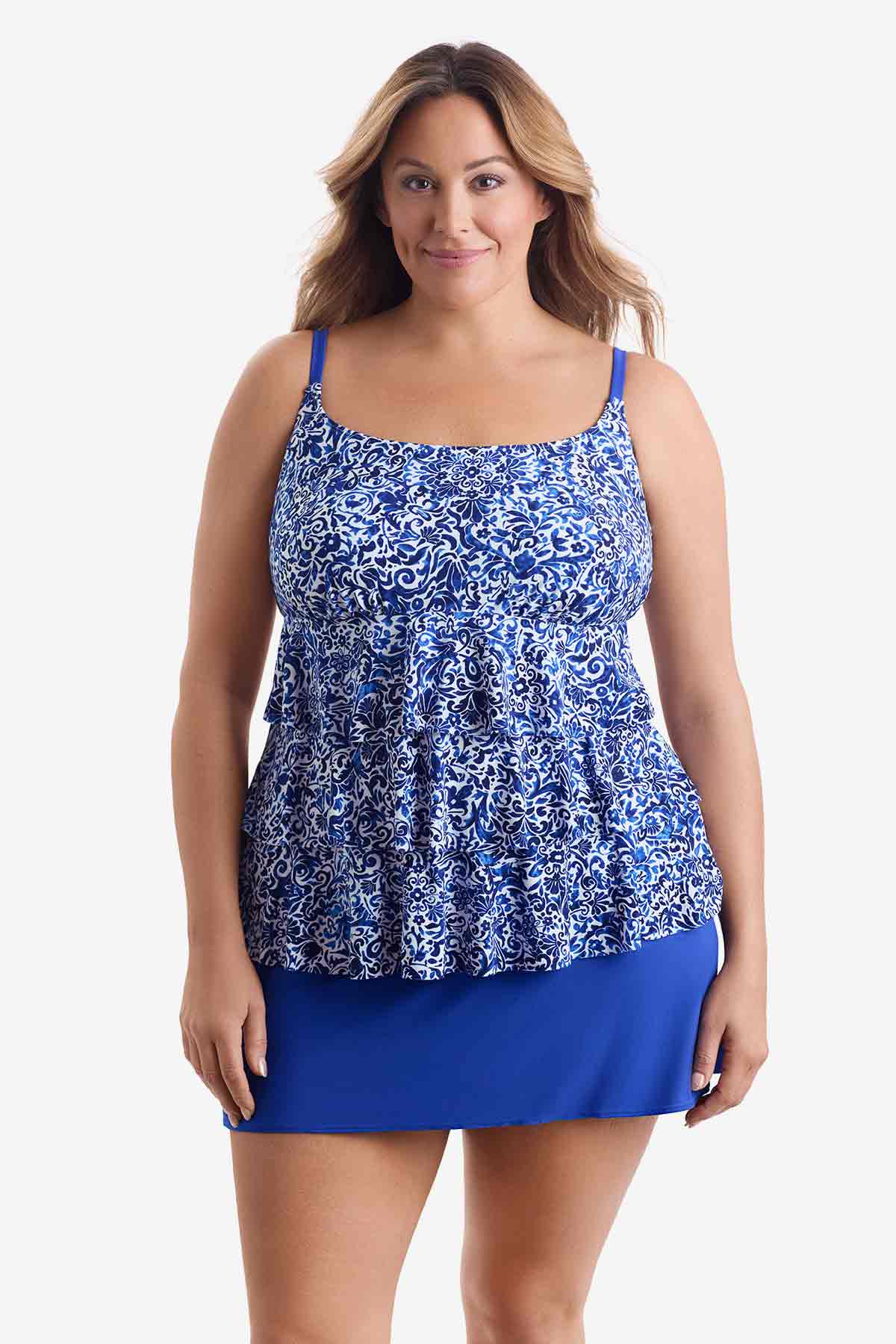 Woman wearing a blue and white patterned tiered one-piece swimsuit