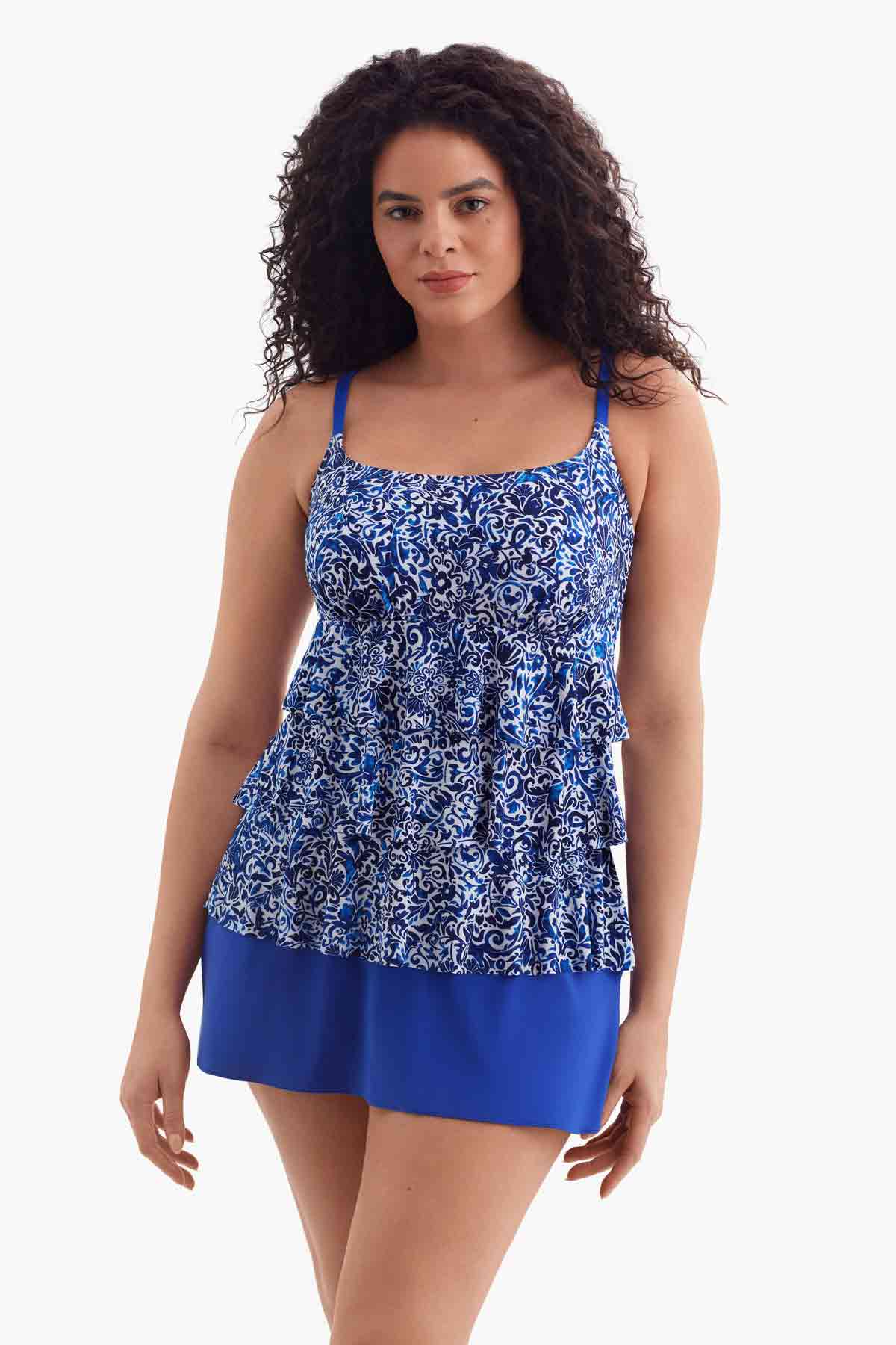 Woman wearing a tiered one-piece swimsuit with a blue and white pattern