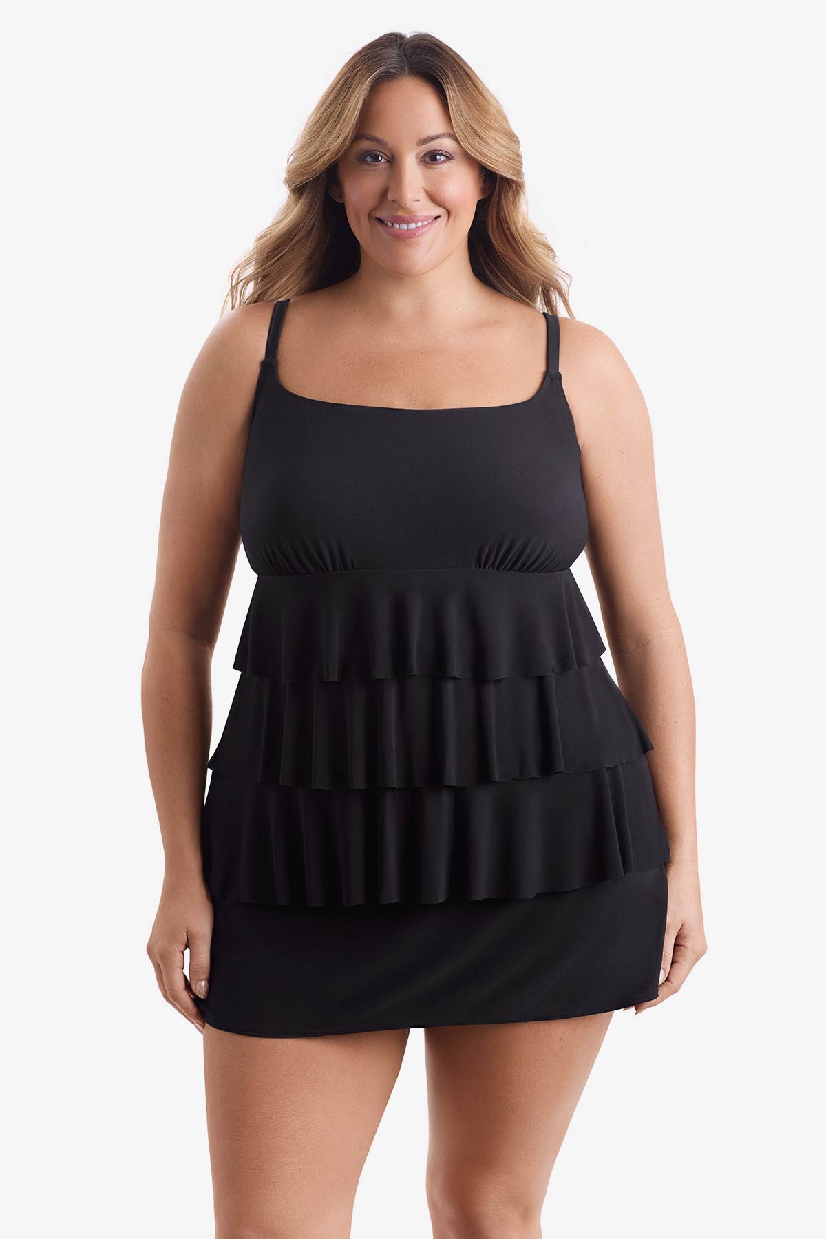 Woman wearing a black tiered one-piece swimsuit