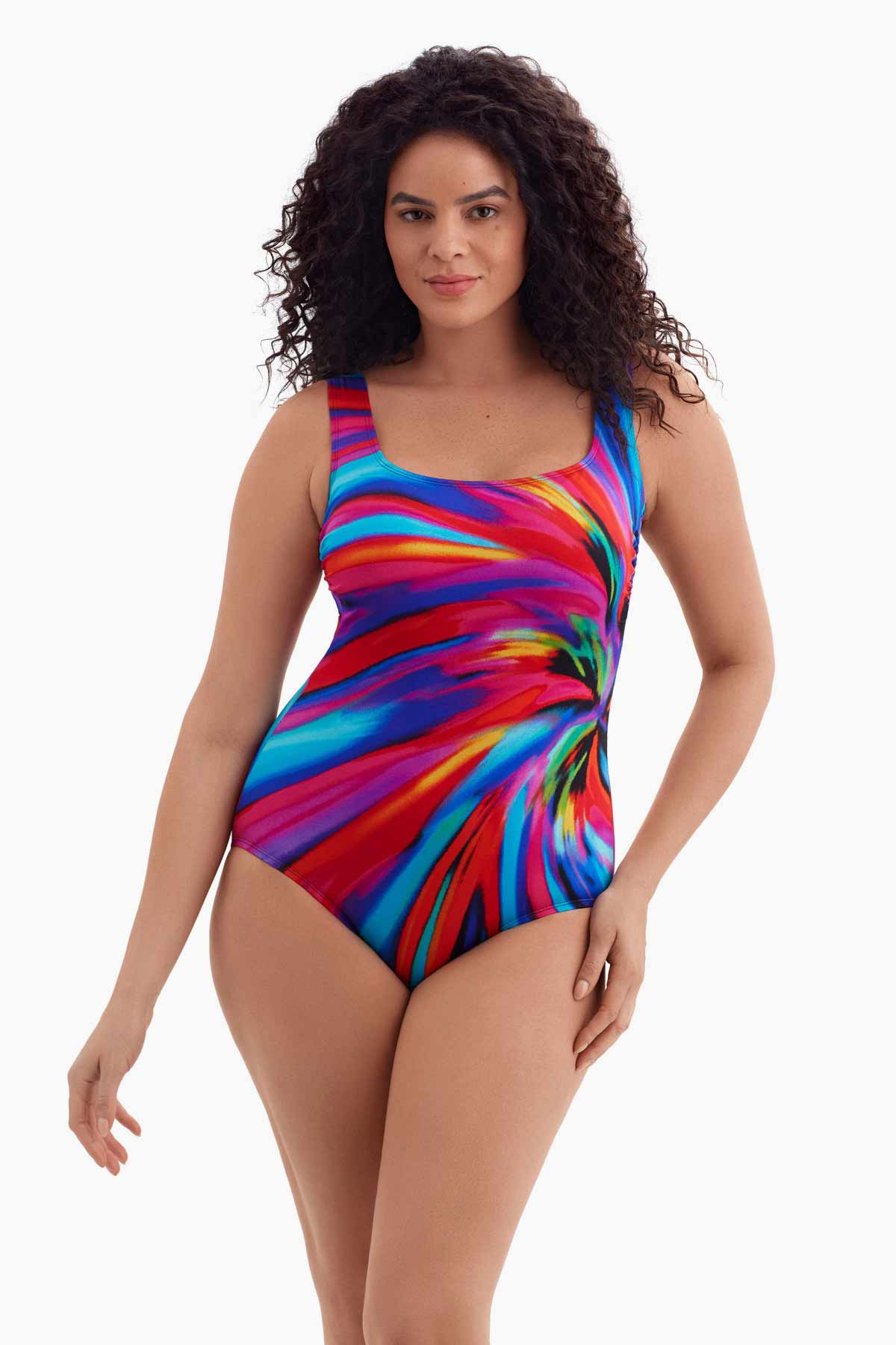 Woman wearing a scoop neck one-piece swimsuit with a multicolored radial pattern