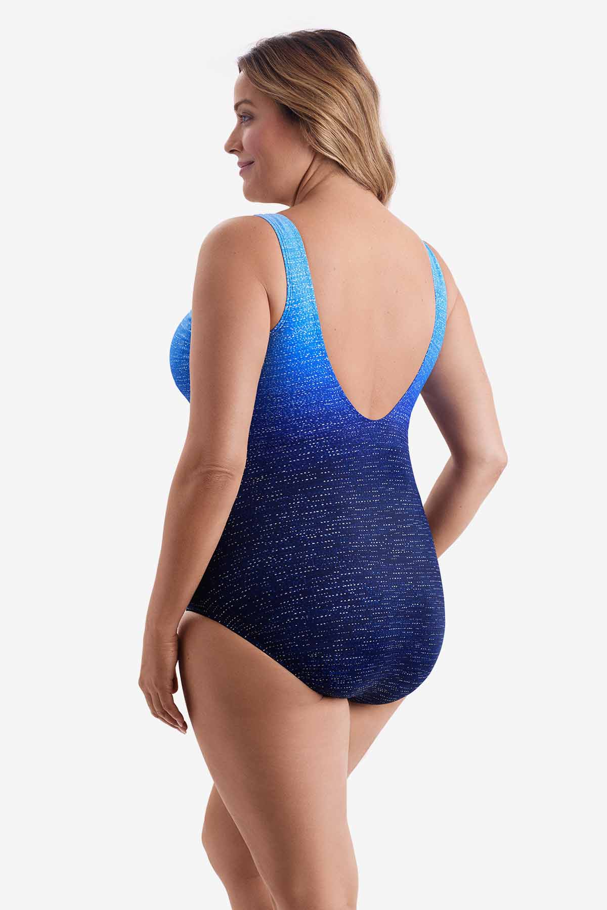 Woman wearing a one-piece swimsuit with a blue ombre pattern