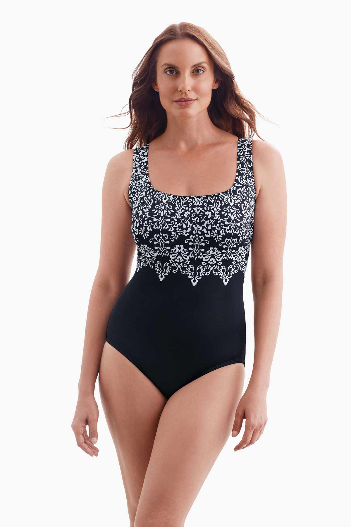 Woman wearing a one-piece swimsuit with a black and white pattern on the bust