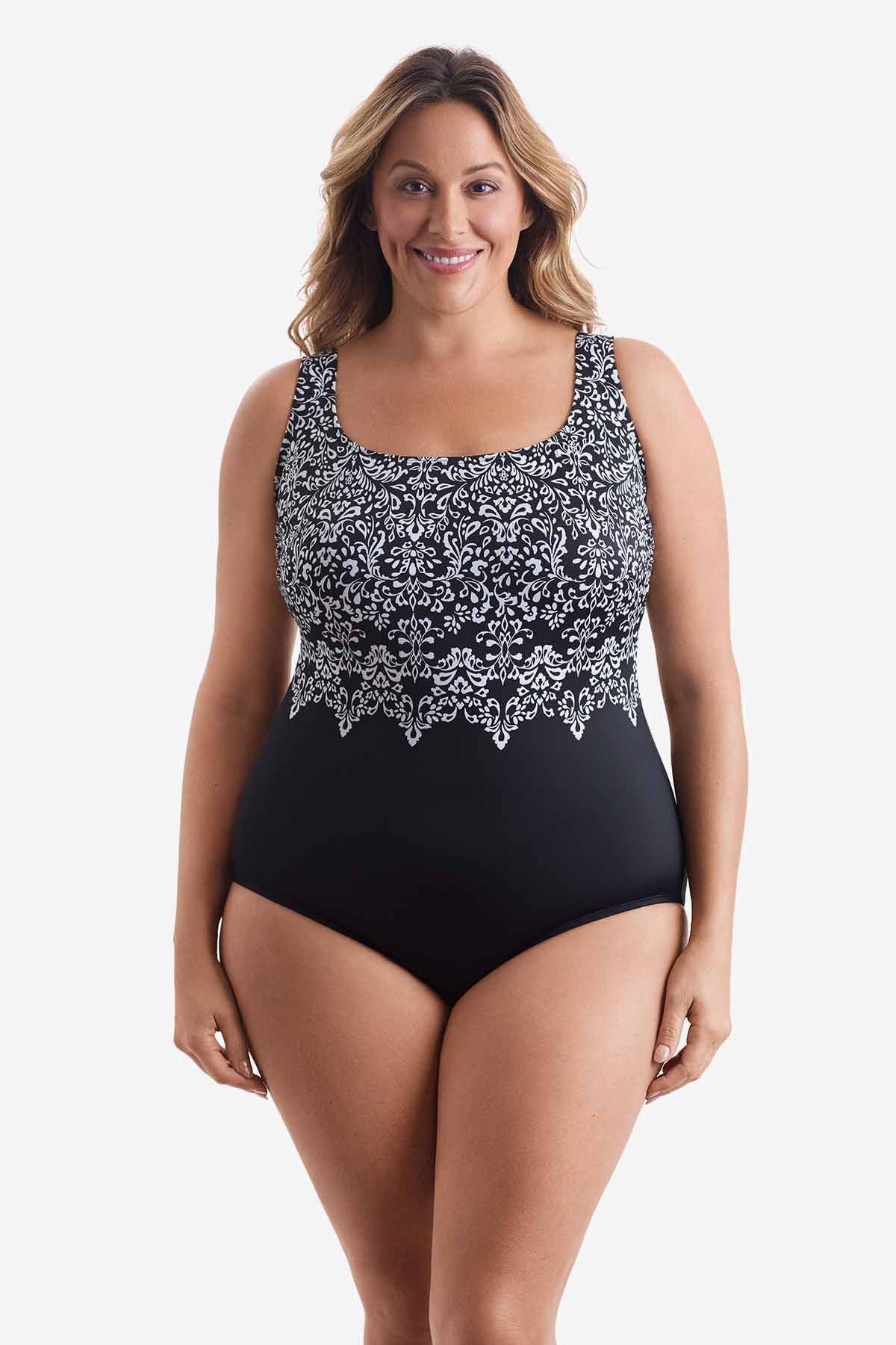 Woman wearing a one-piece swimsuit with a black and white pattern on the bust