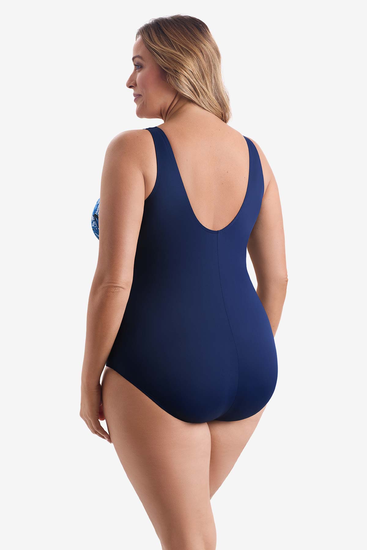 Woman faced left wearing a blue abstract printed one-piece swimsuit