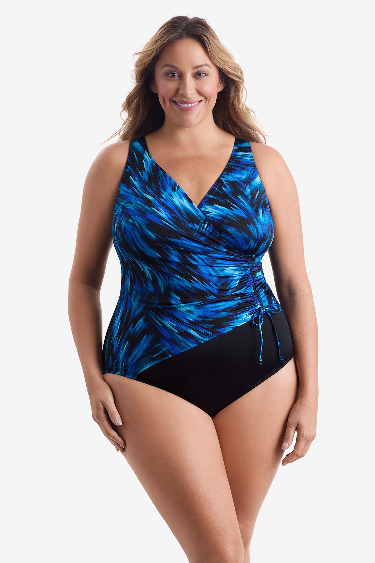 Woman wearing a black and blue feathered pattern one-piece swimsuit with a side tie
