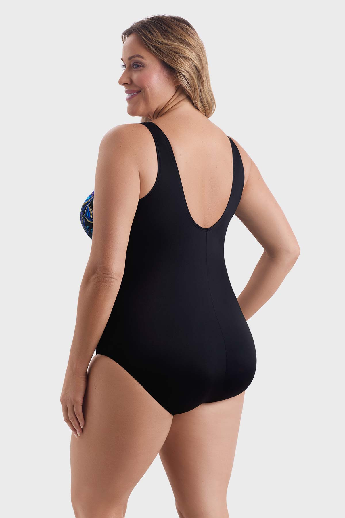 Woman faced left wearing a blue and gold flower printed one-piece swimsuit