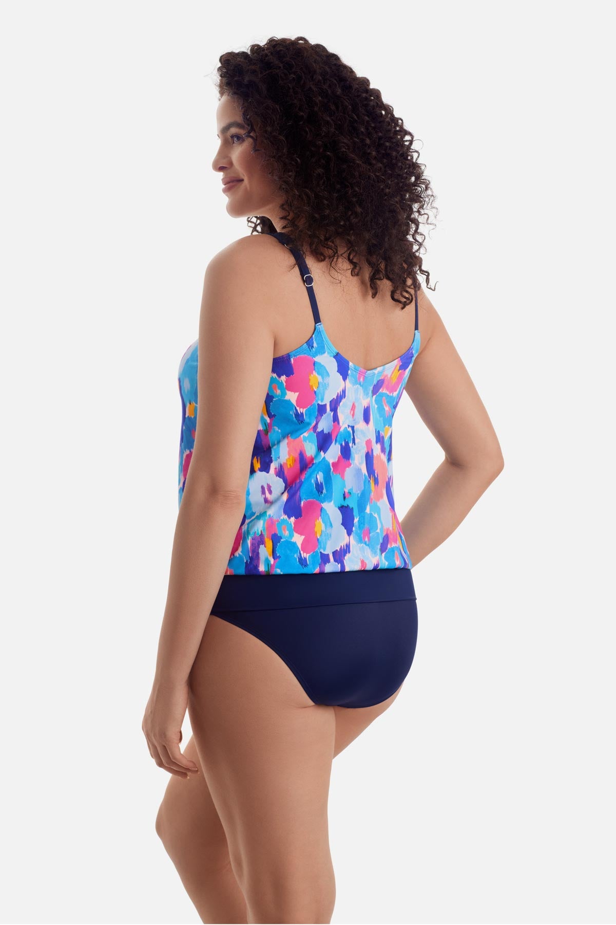 Woman turned left wearing a multicolor abstract print blouson tankini top