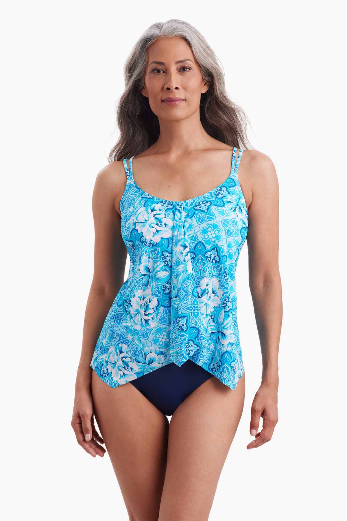 Woman wearing a tankini top with an abstract blue pattern