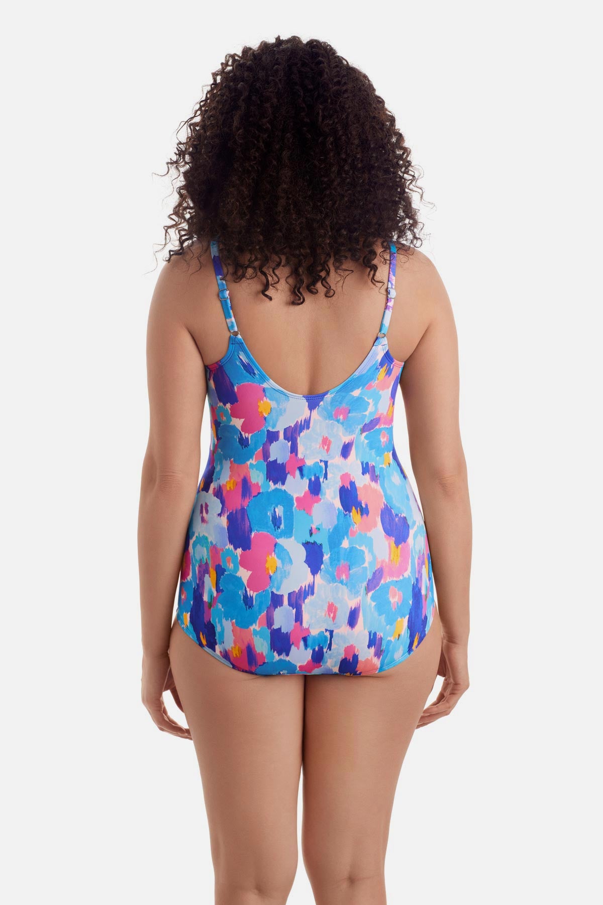Woman turned away wearing a multicolor abstract printed sarong one-piece swimsuit