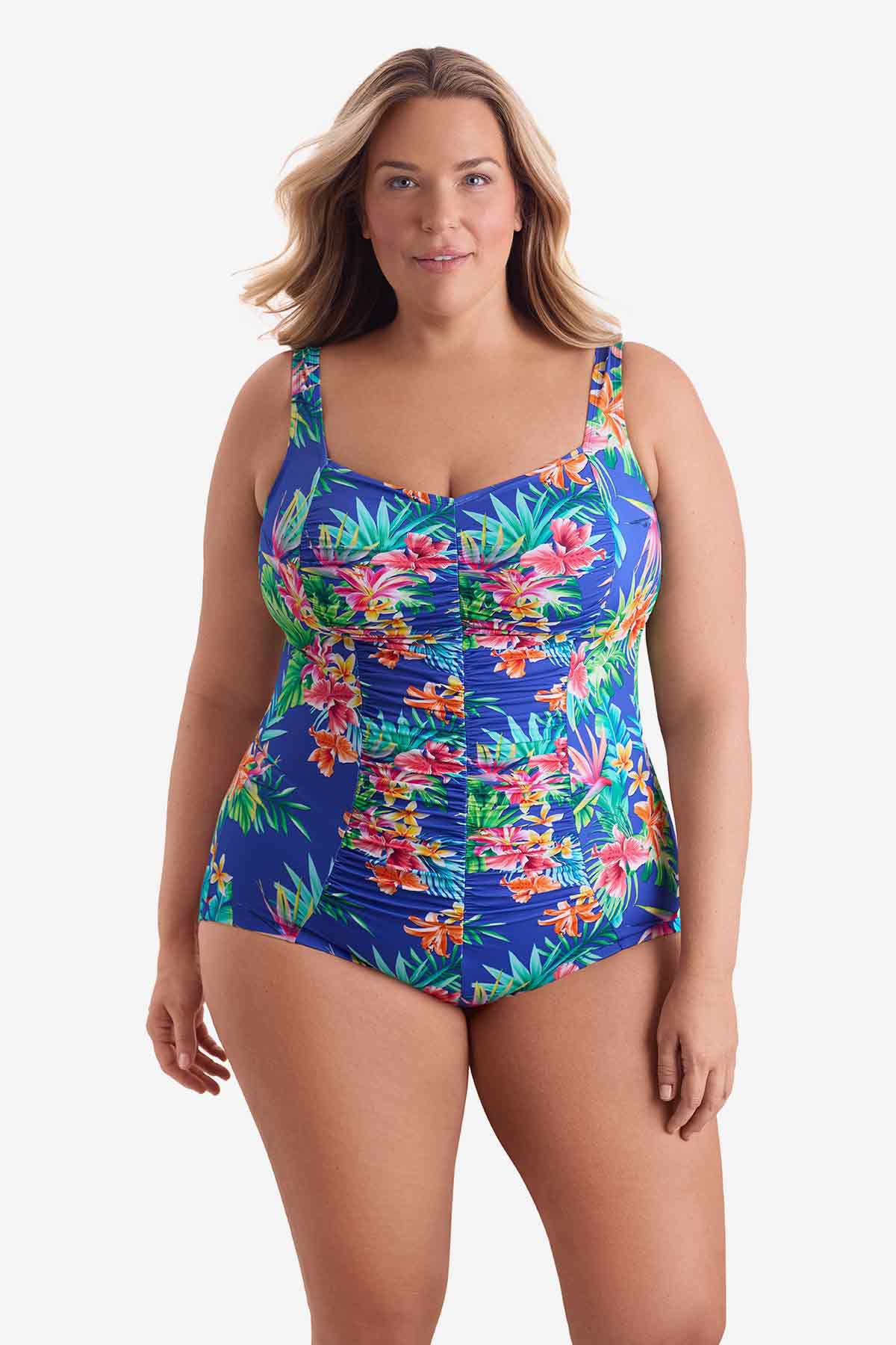 Woman wearing a multicolored palm leaf tropical printed one-piece swimsuit
