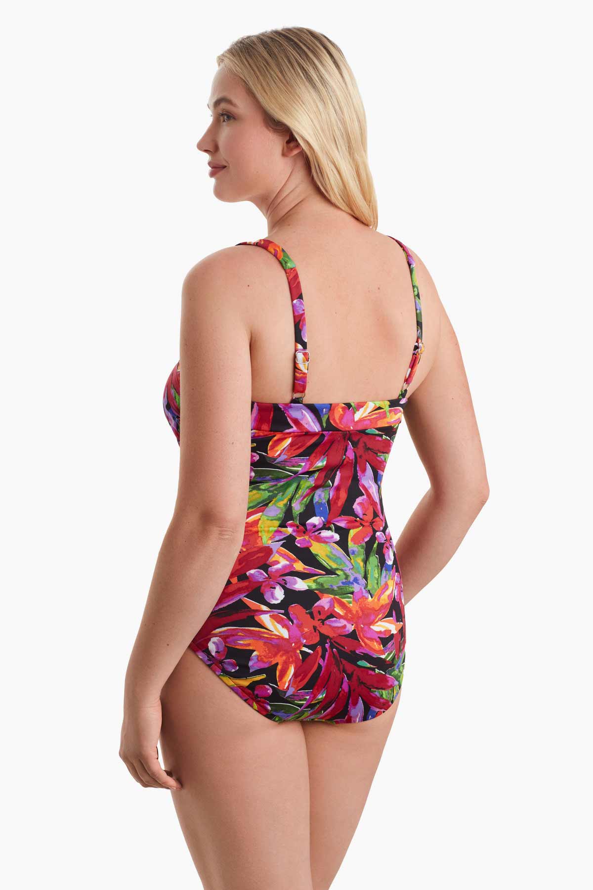 Woman faced left wearing a multicolored one-piece swimsuit