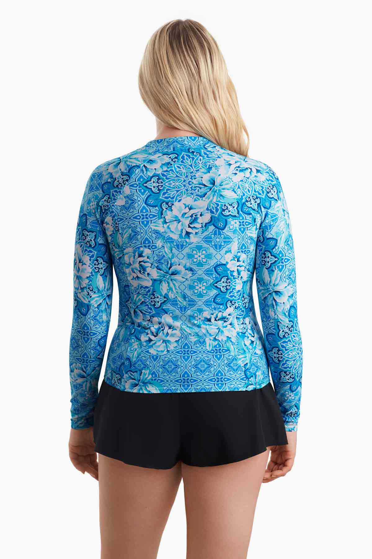 Woman faced away to show the detail of the blue abstract print of the sun shirt