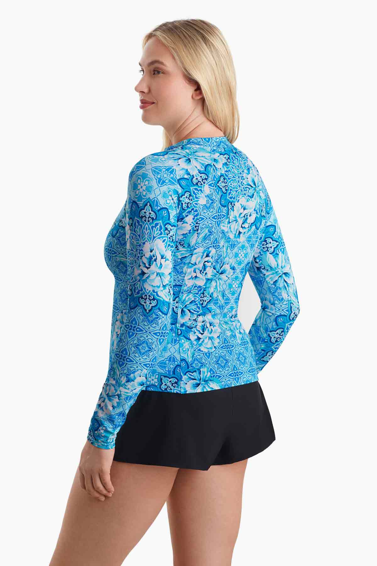 Woman turned to the side to show blue abstract print detail of the sun shirt