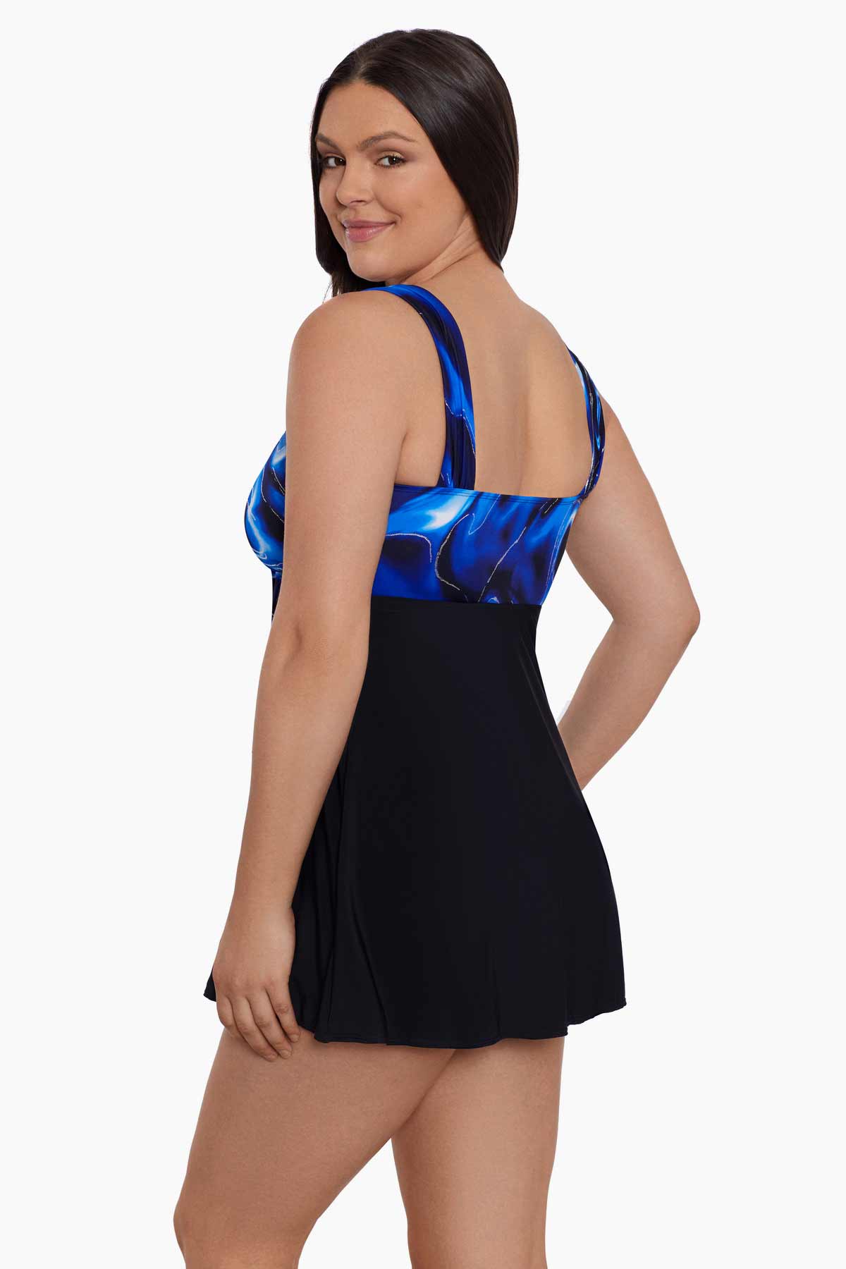 Woman turned left wearing a blue and black oil slick printed bust swim dress
