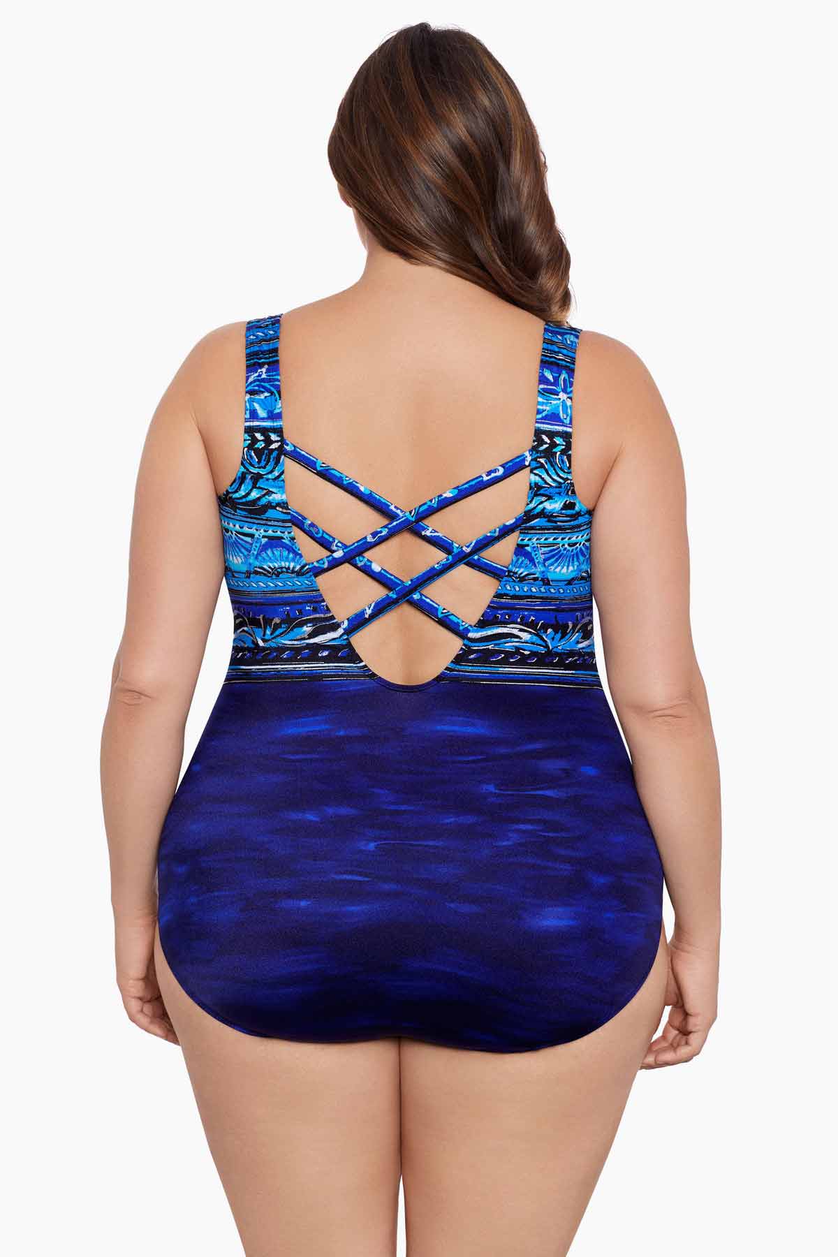 Woman faced away wearing a blue ombre abstract printed one-piece swimsuit and X back