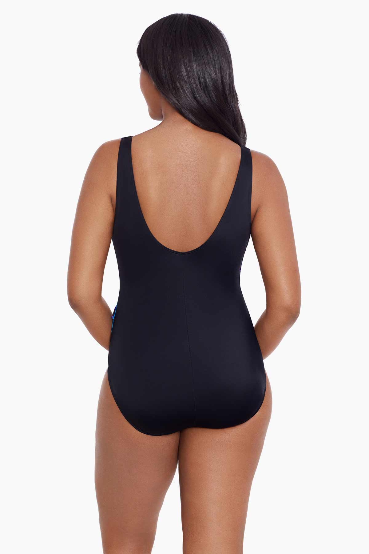 Woman turned away wearing a blue and gold floral printed one-piece swimsuit