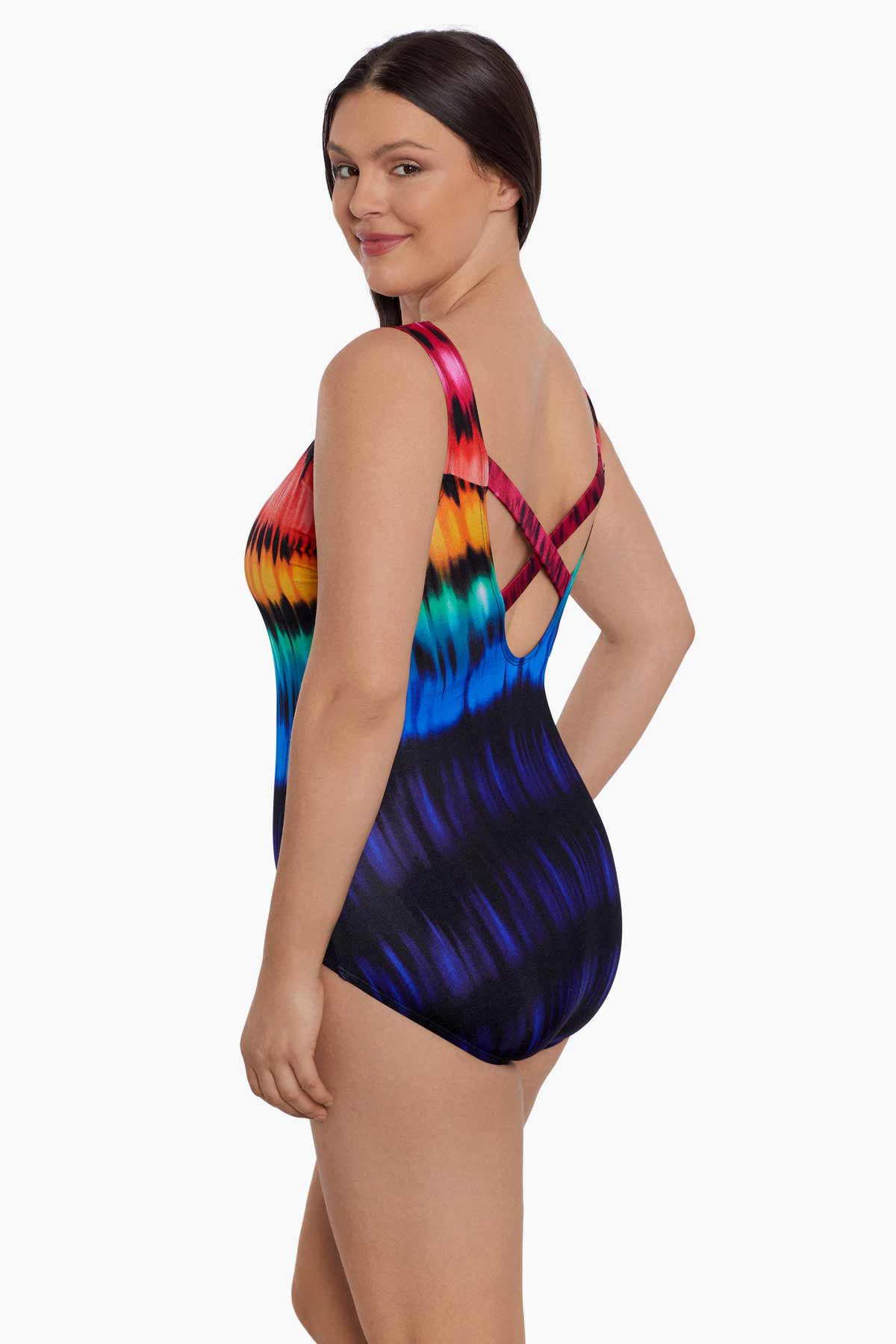 Woman turned left wearing a rainbow tie dye one-piece swimsuit